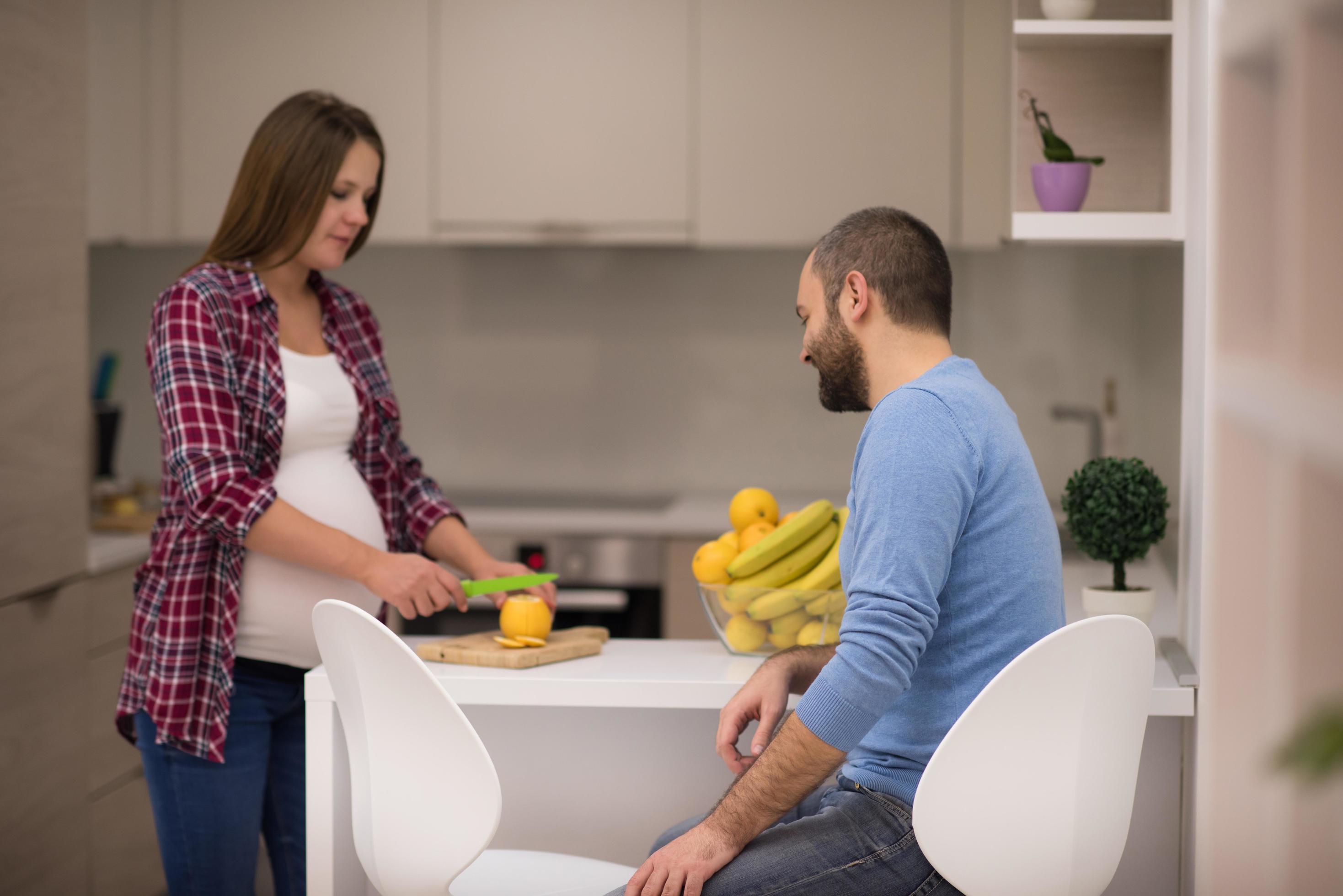 couple cooking food fruit lemon juice at kitchen Stock Free