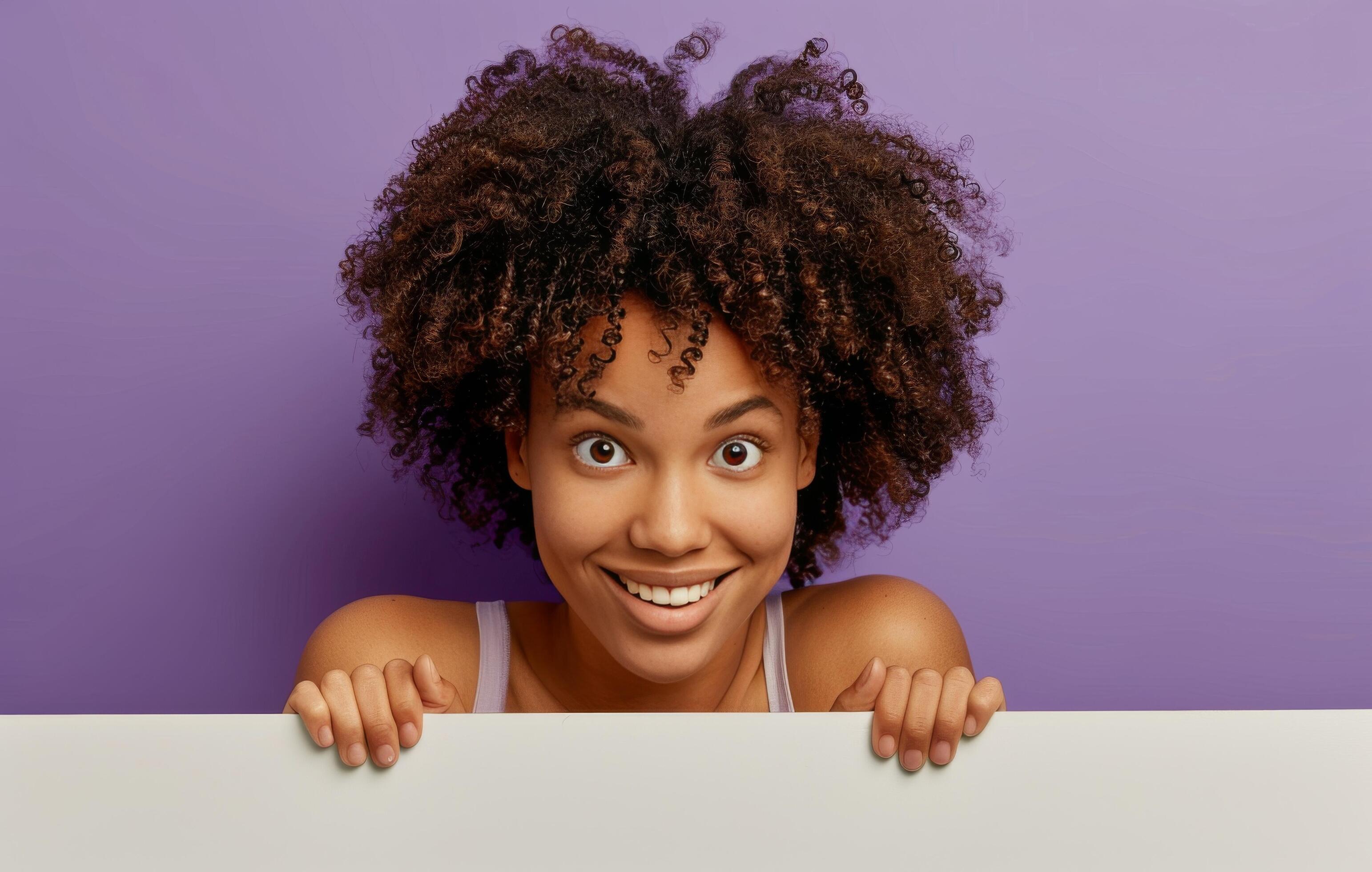 Smiling Woman Peeking Over Light Purple Background Stock Free