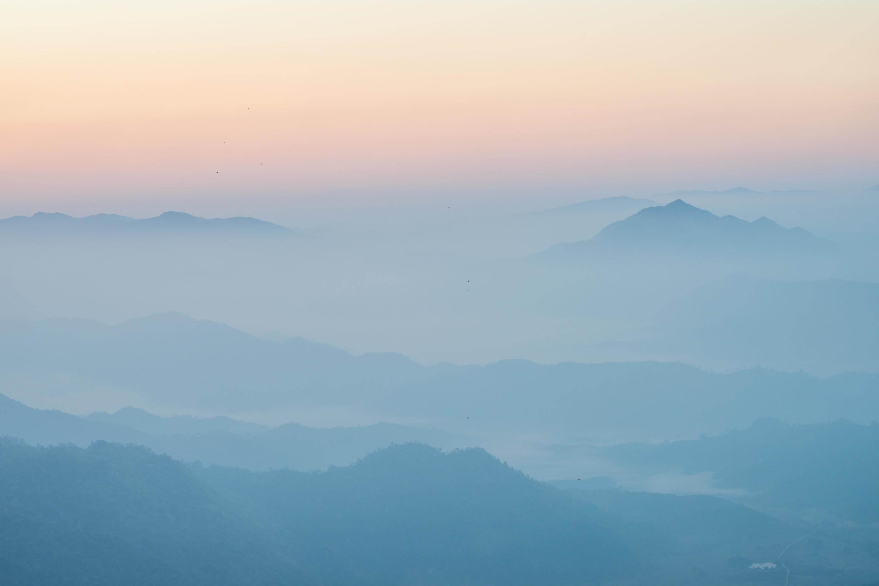 Scenery view of the mountains in the mist layer background. View from Phu Chi Fah in Chiang Rai province of Thailand. Stock Free