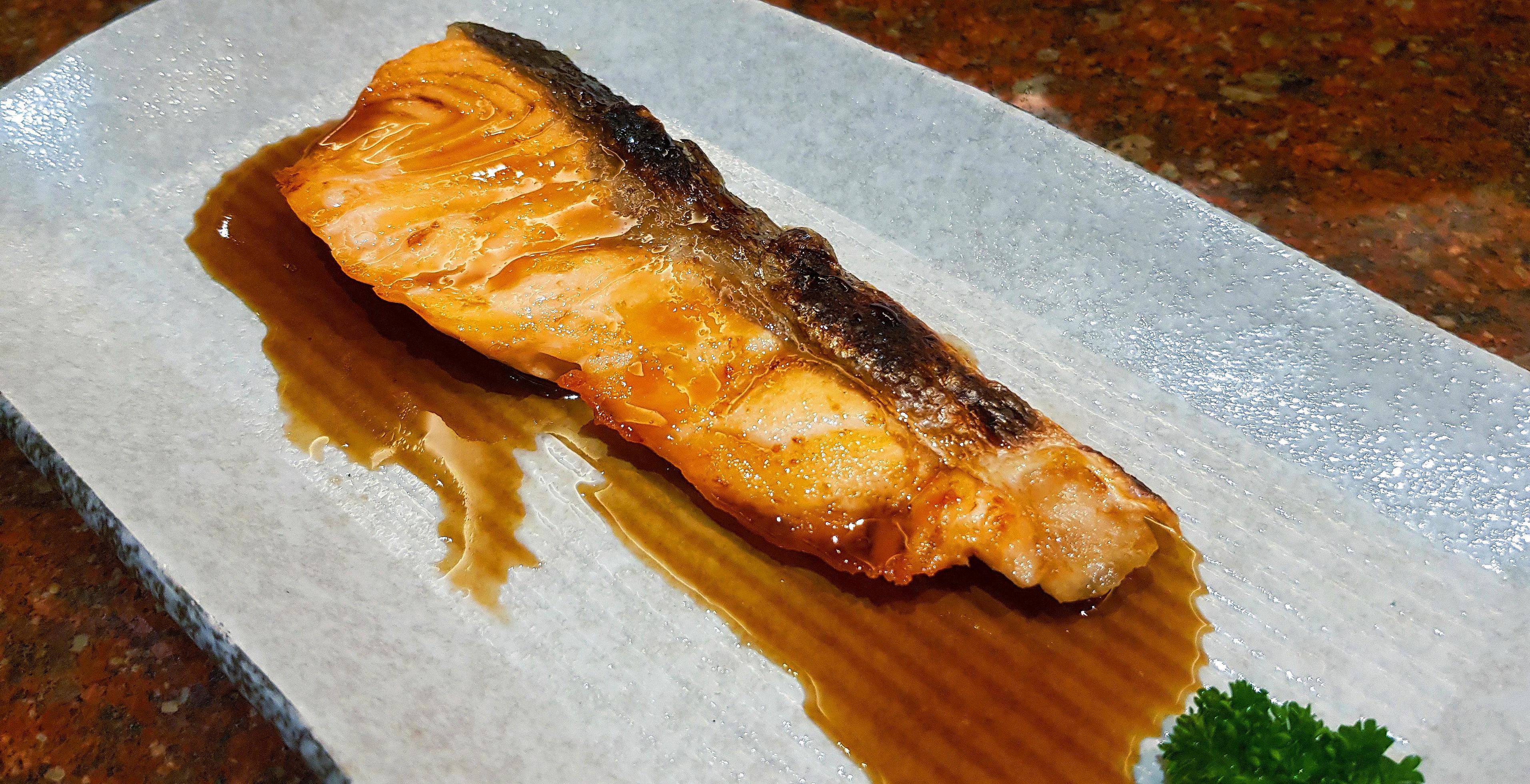 Grilled fresh salmon with Teriyaki sauce on white plate or dish at Japanese restaurant. Top view of Asian or fish food. Close up Barbeque seafood. Stock Free