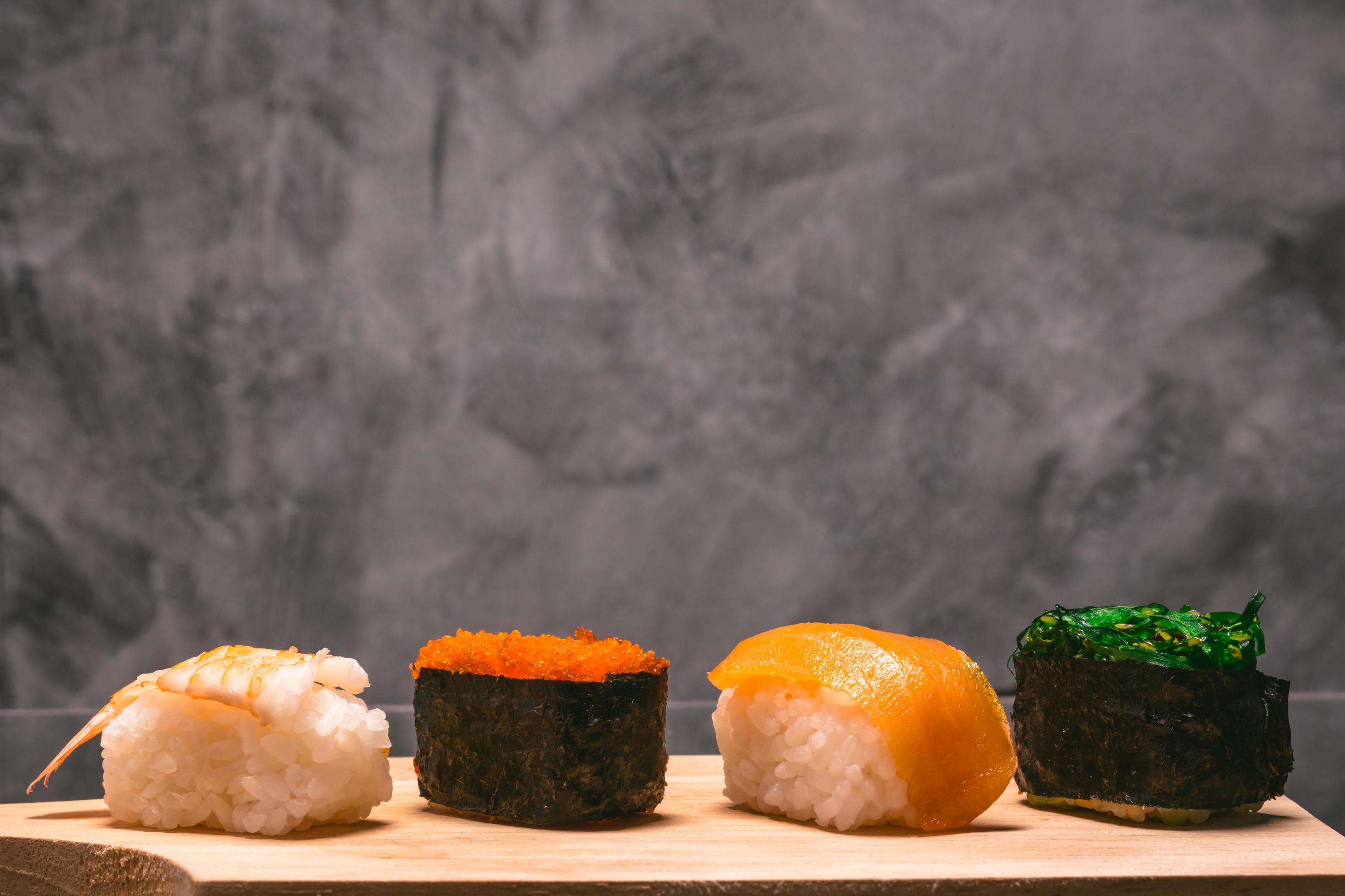 Sushi set on wooden plate on gray grunge background, Japanese food. Stock Free