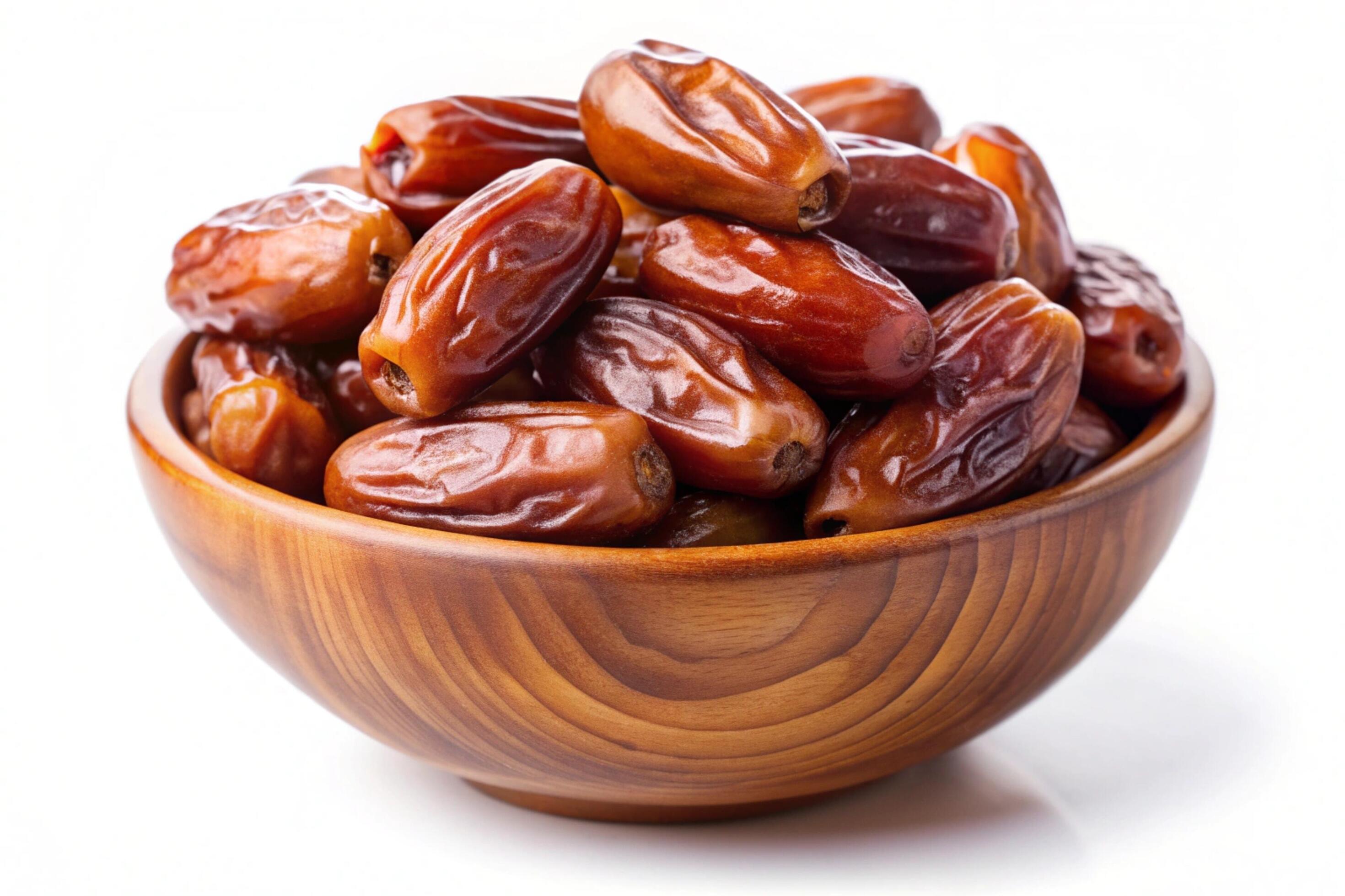 Dates in wood bowl isolated on white background Stock Free