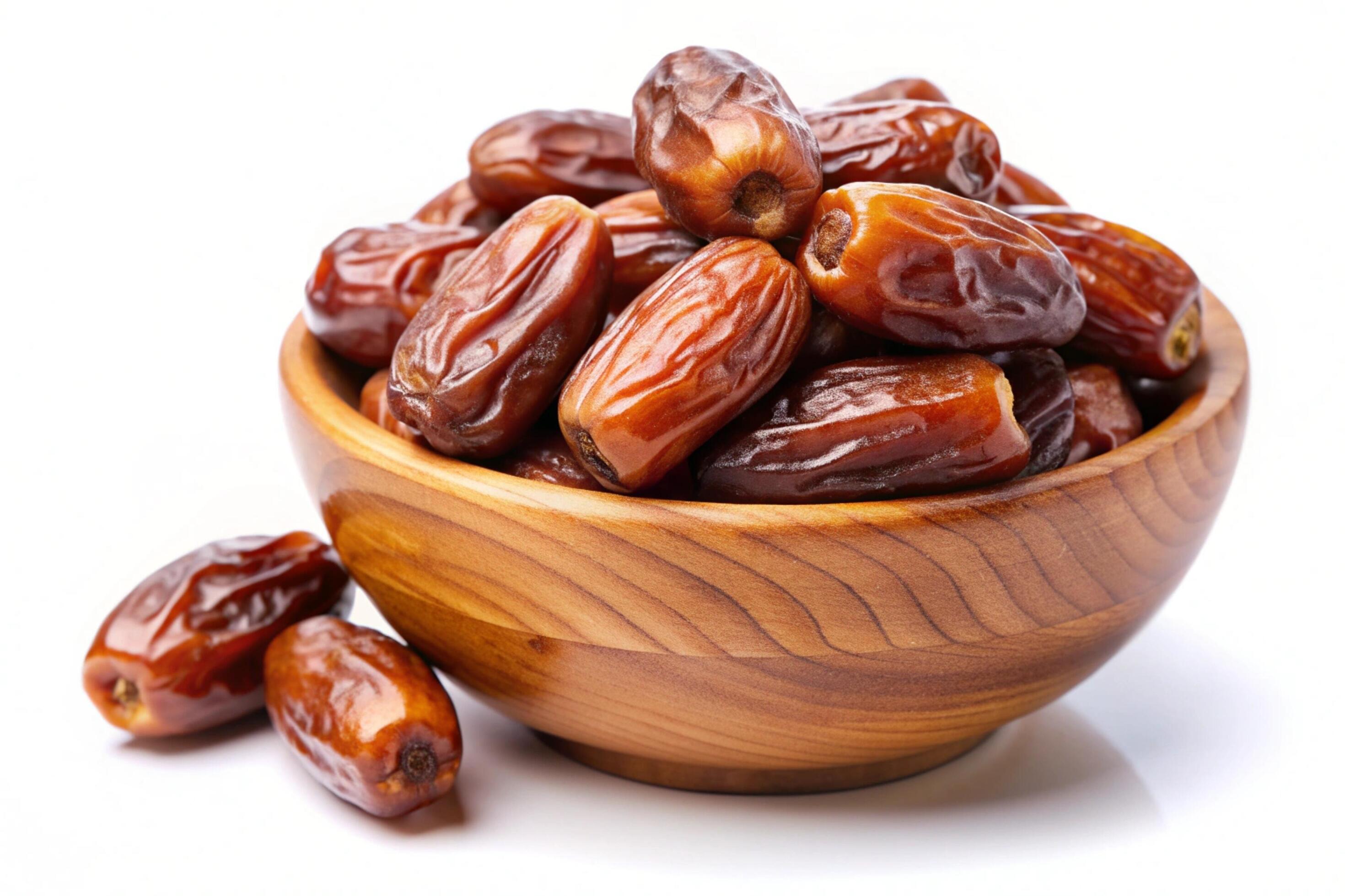 Dates in wood bowl isolated on white background Stock Free