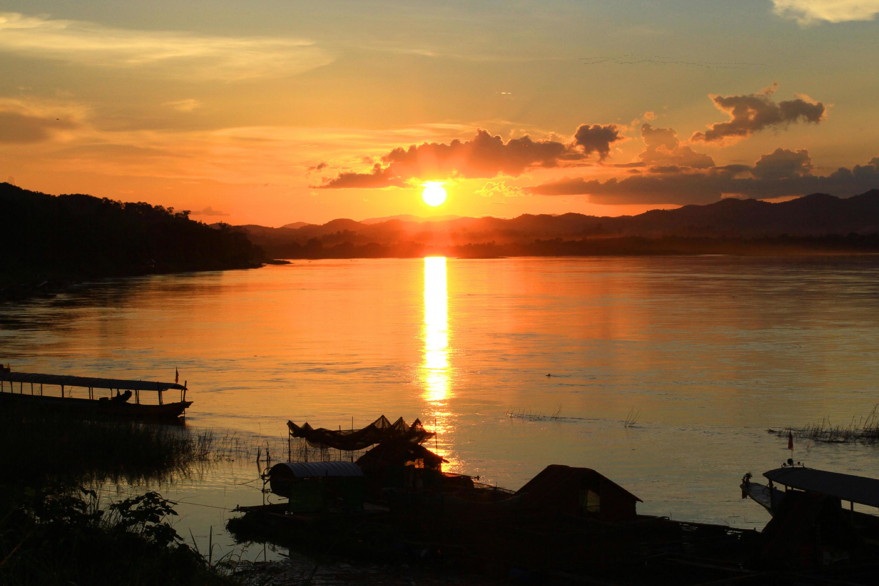 Tradition of Long tail boat and fisherman in beautiful sunset twilight at Khong river the Thai-Laos border Chaingkhan distric Thailand Stock Free