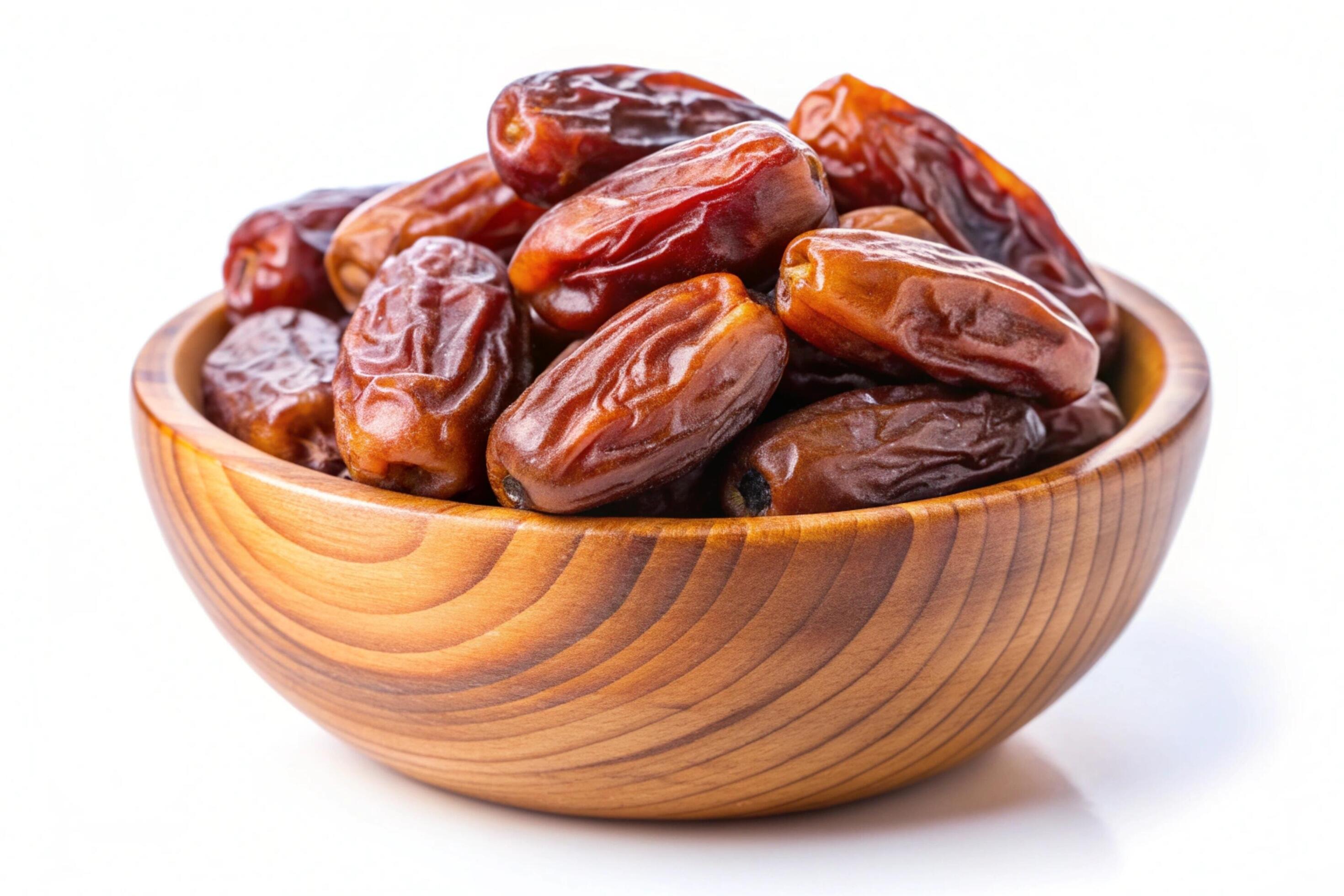 Dates in wood bowl isolated on white background Stock Free