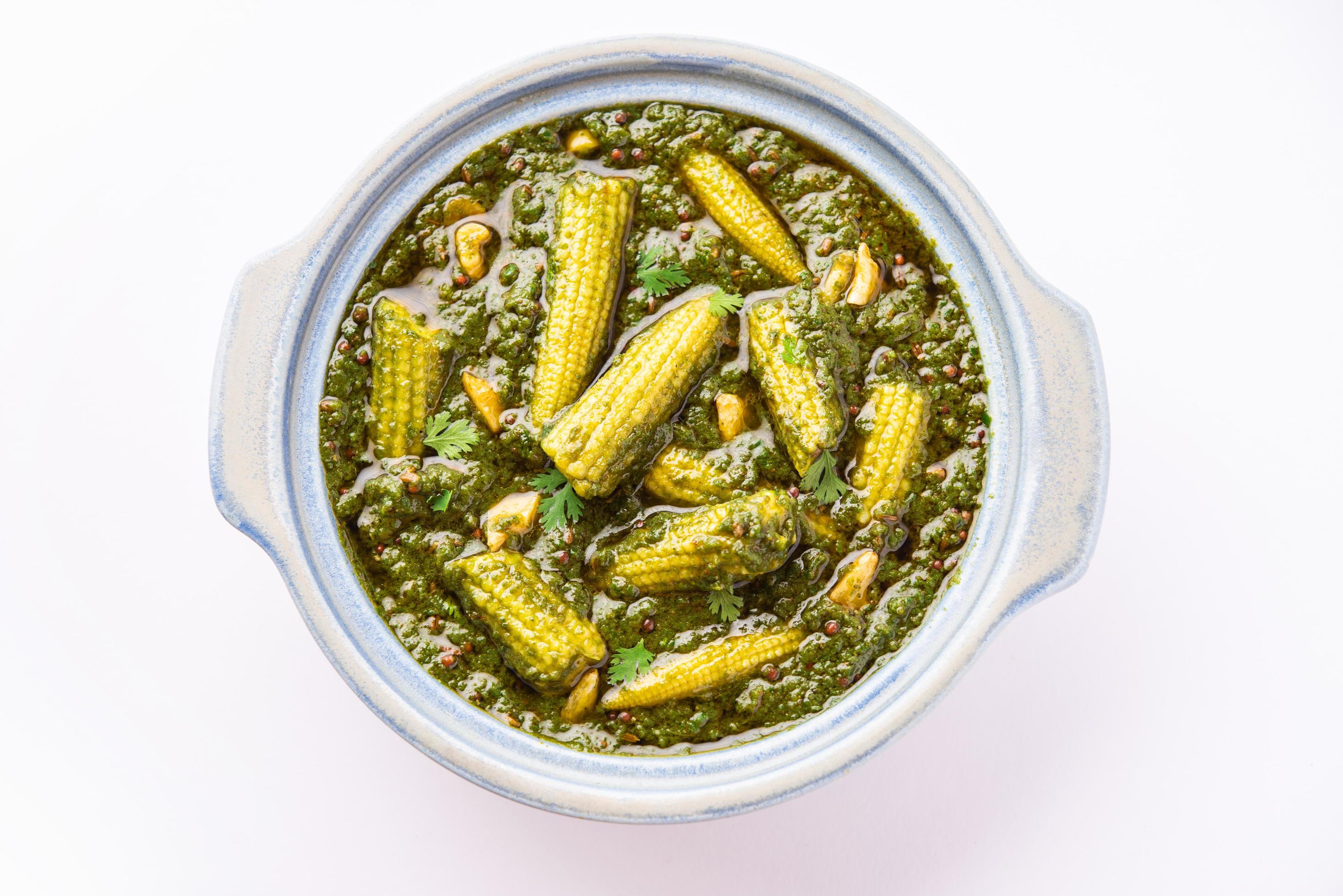 palak baby corn sabzi also known as spinach makai curry served with rice or roti, Indian food Stock Free