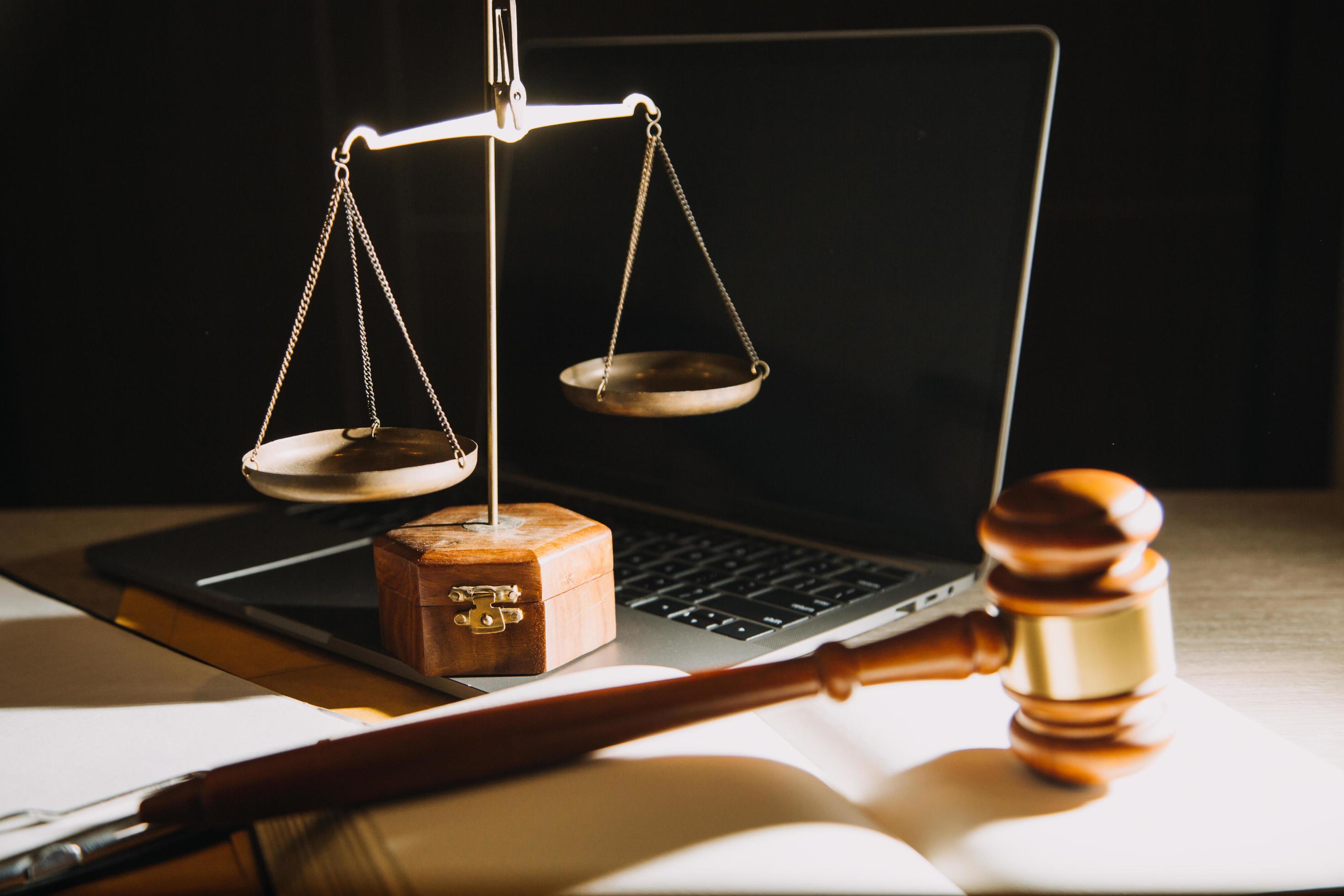 Business and lawyers discussing contract papers with brass scale on desk in office. Law, legal services, advice, justice and law concept Stock Free