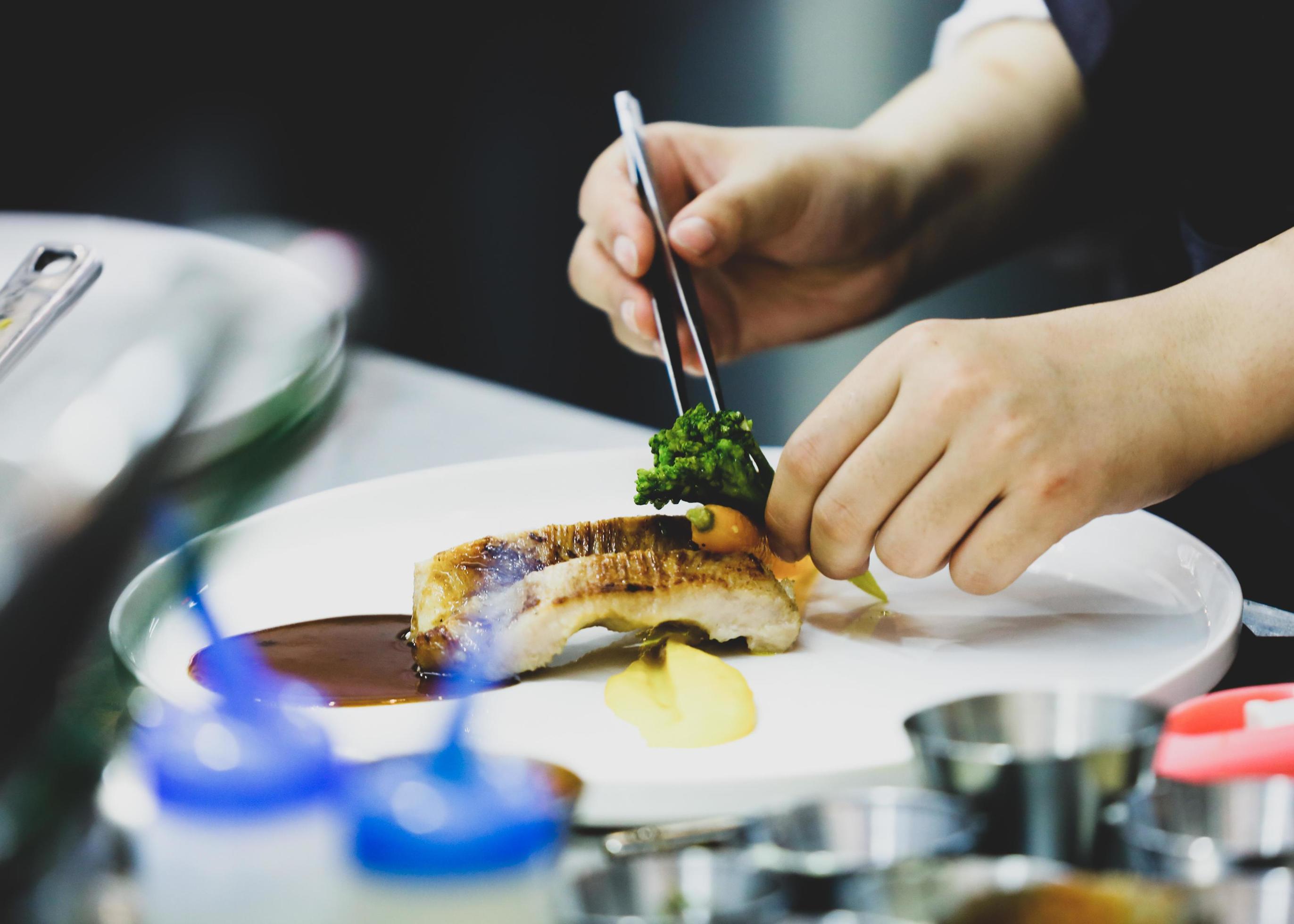 Chef preparing food in the kitchen, chef cooking, Chef decorating dish Stock Free