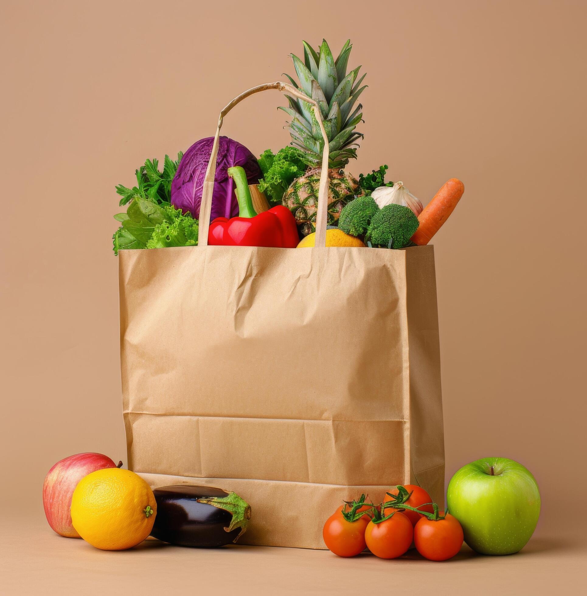 Fresh Produce Bag Filled With Colorful Fruits and Vegetables on Light Brown Background Stock Free