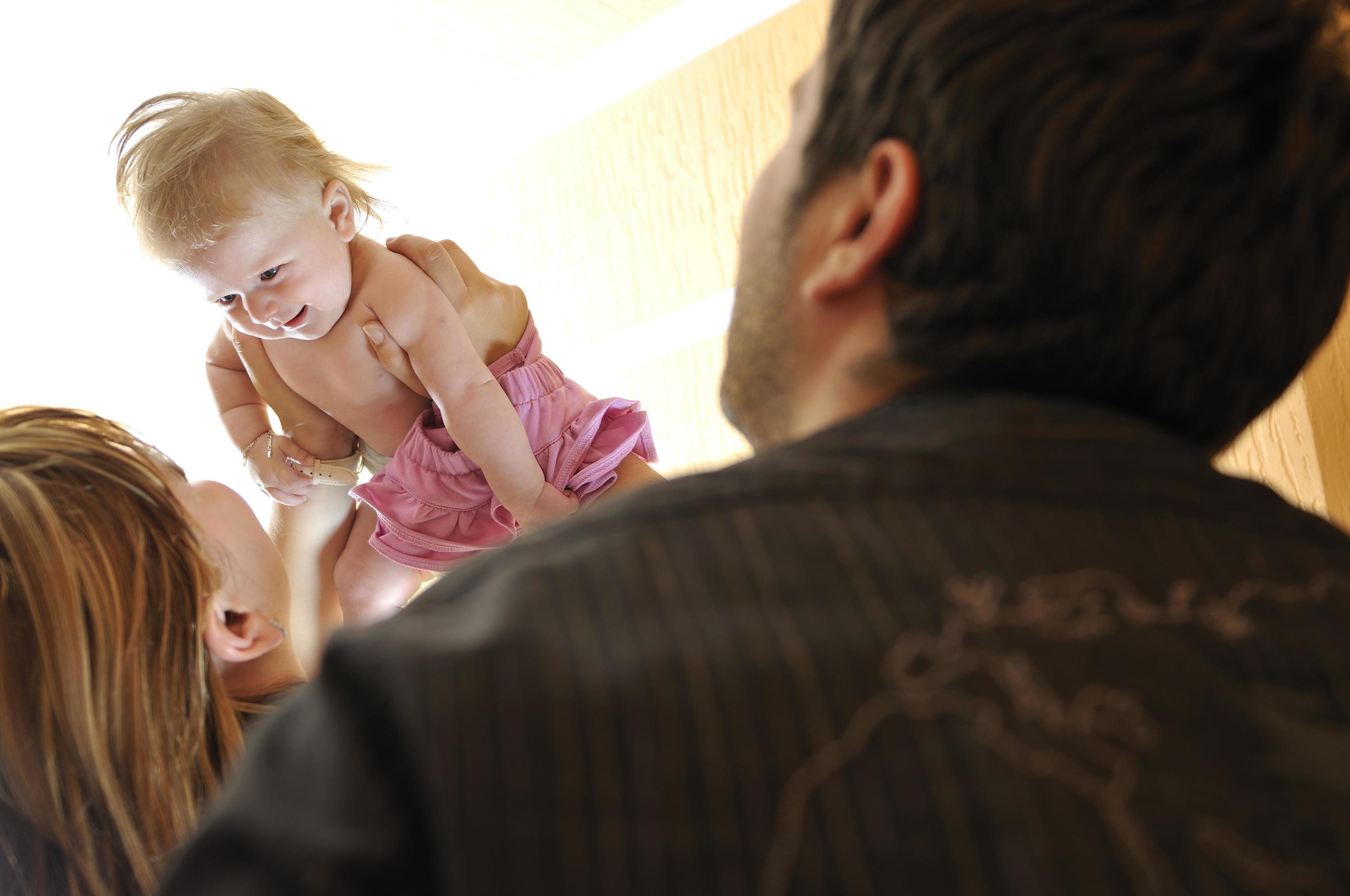 portrait of young family with cute little babby Stock Free