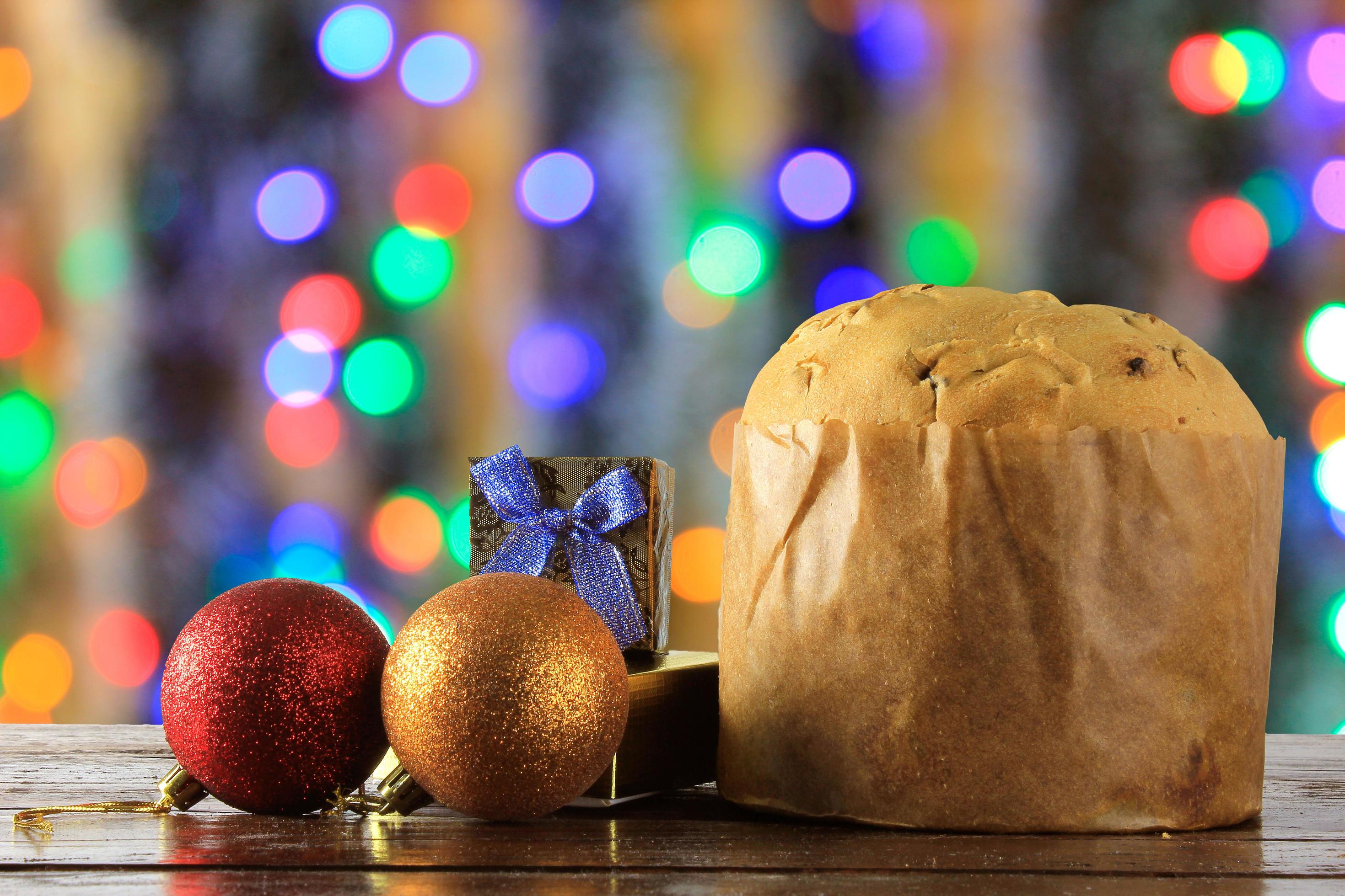 panettone, decorative food, on wooden table, blurred lights in the background Stock Free