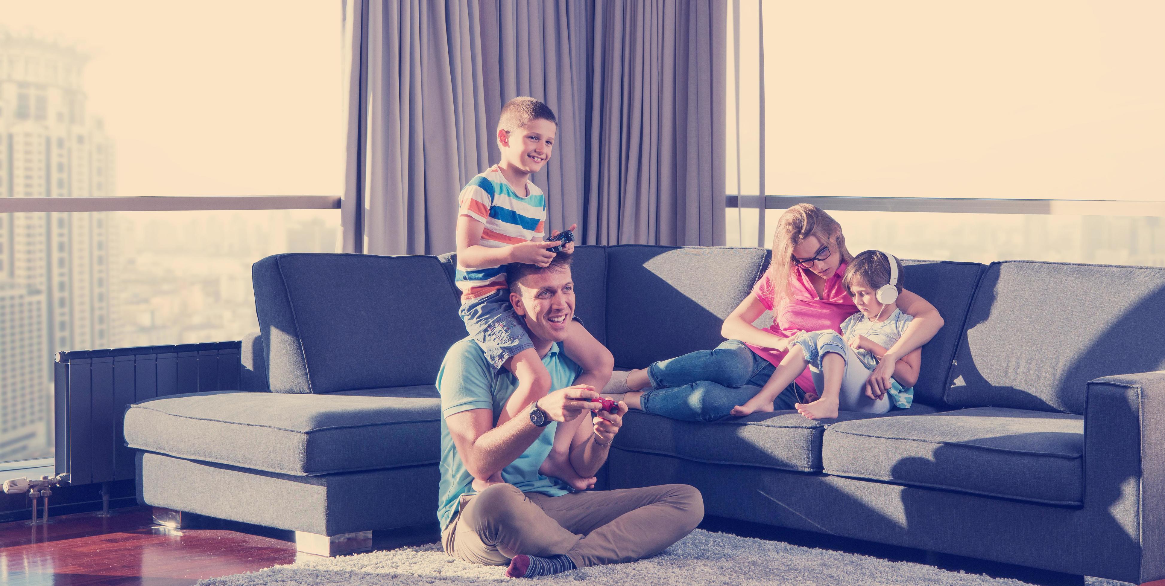 
									Happy family playing a video game Stock Free