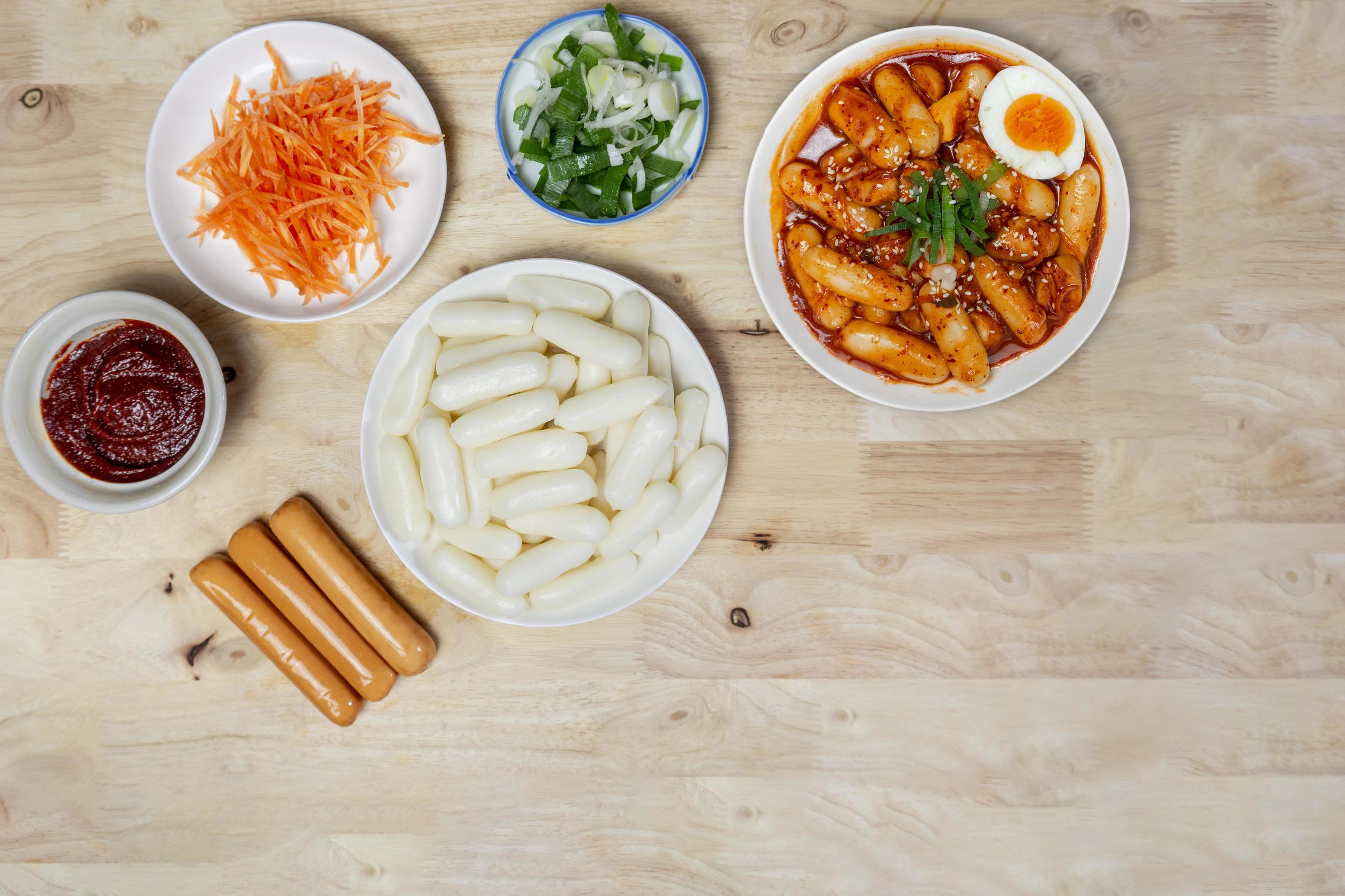 Top view raw ingredient for making Tteteokbokki Spicy Rice Cakes Korean street food on the wooden table with copy space. Stock Free