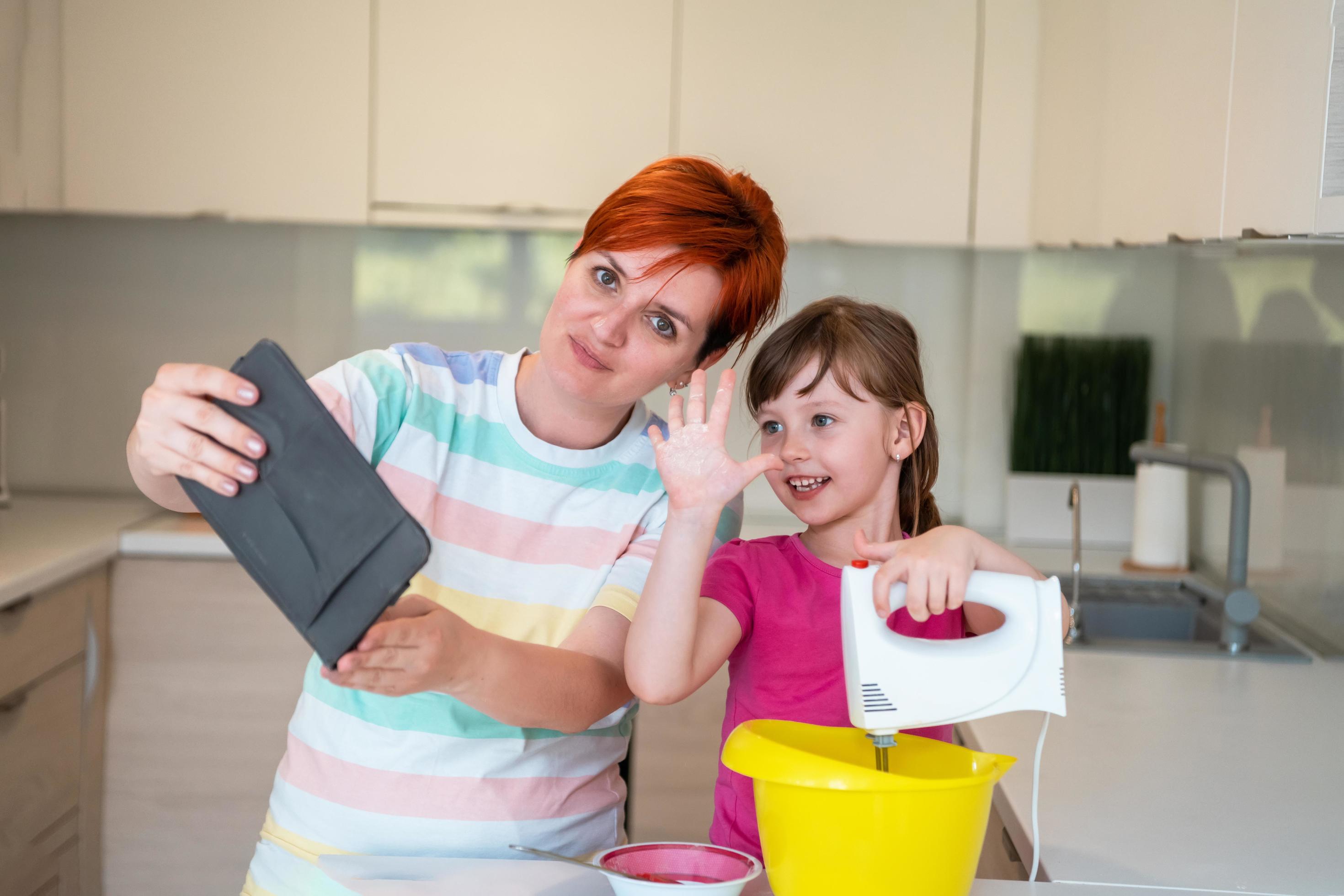 little girl and mom making tastz cake in kithen family having fun at home Stock Free