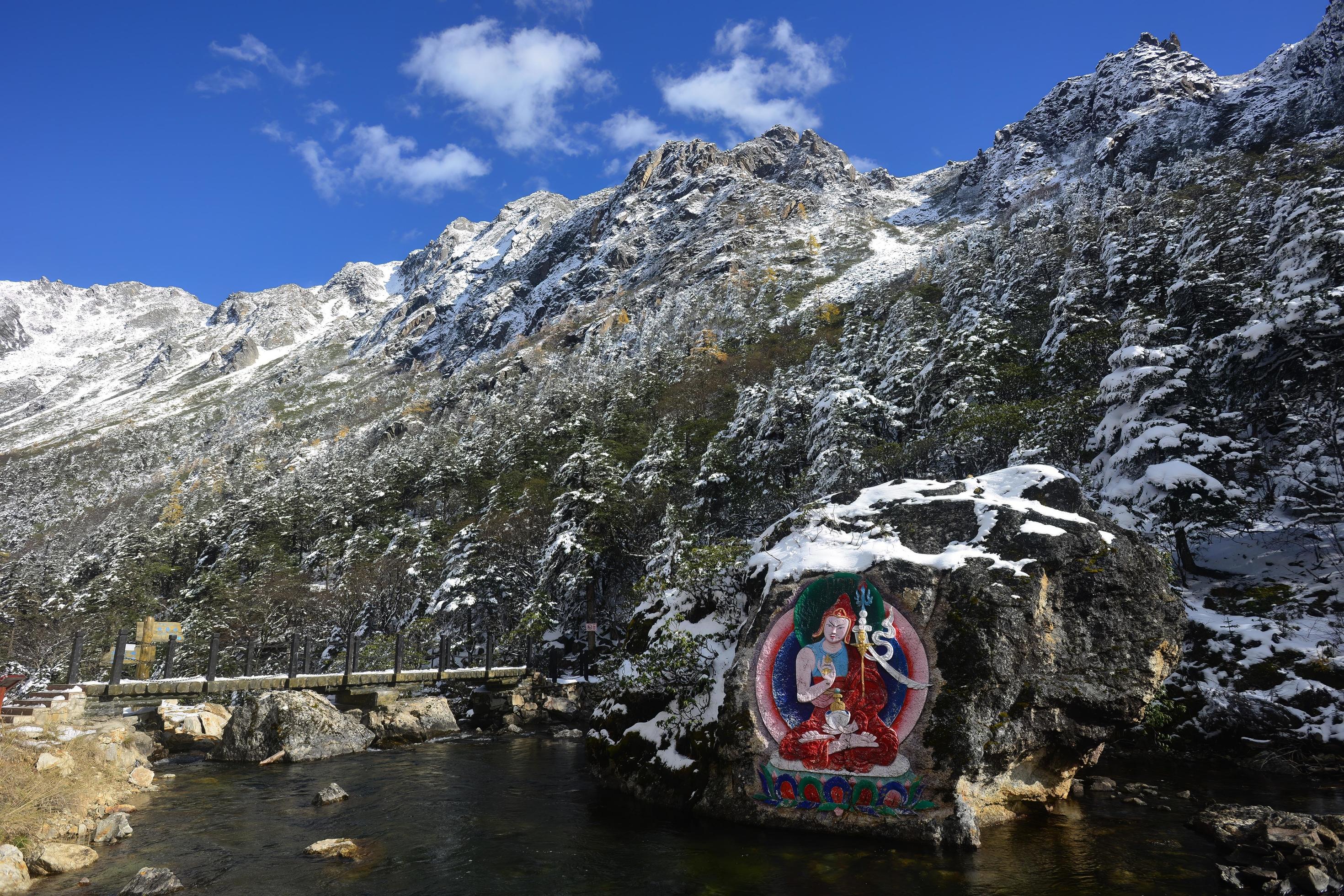 Stone carvings and paintings of Tibetan Buddha statues in the mountains of western Sichuan, China Stock Free