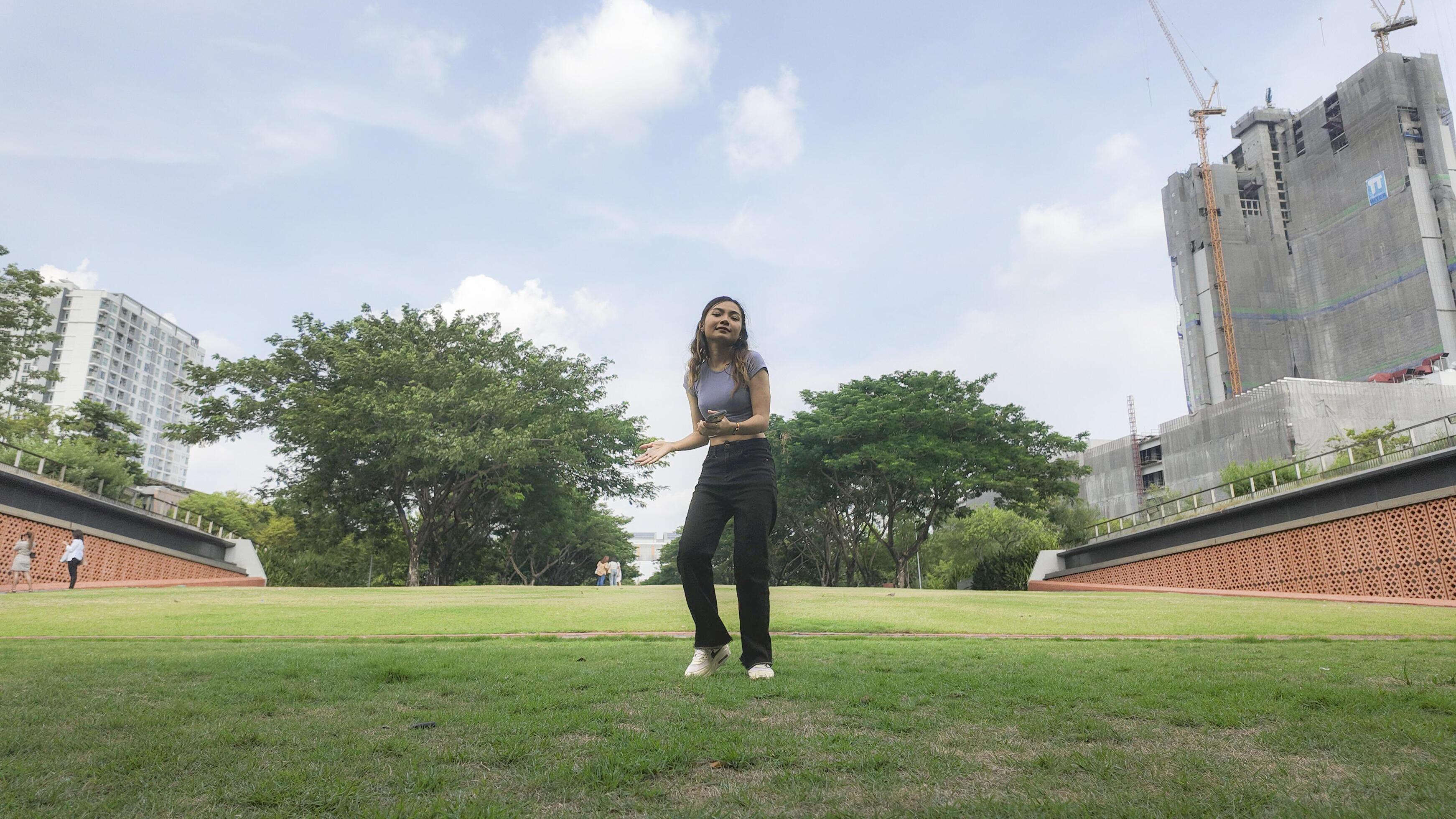 Asian women do freestyle hip hop and breakdancing in a public space in the middle of the city. With a cheerful and happy attitude Stock Free