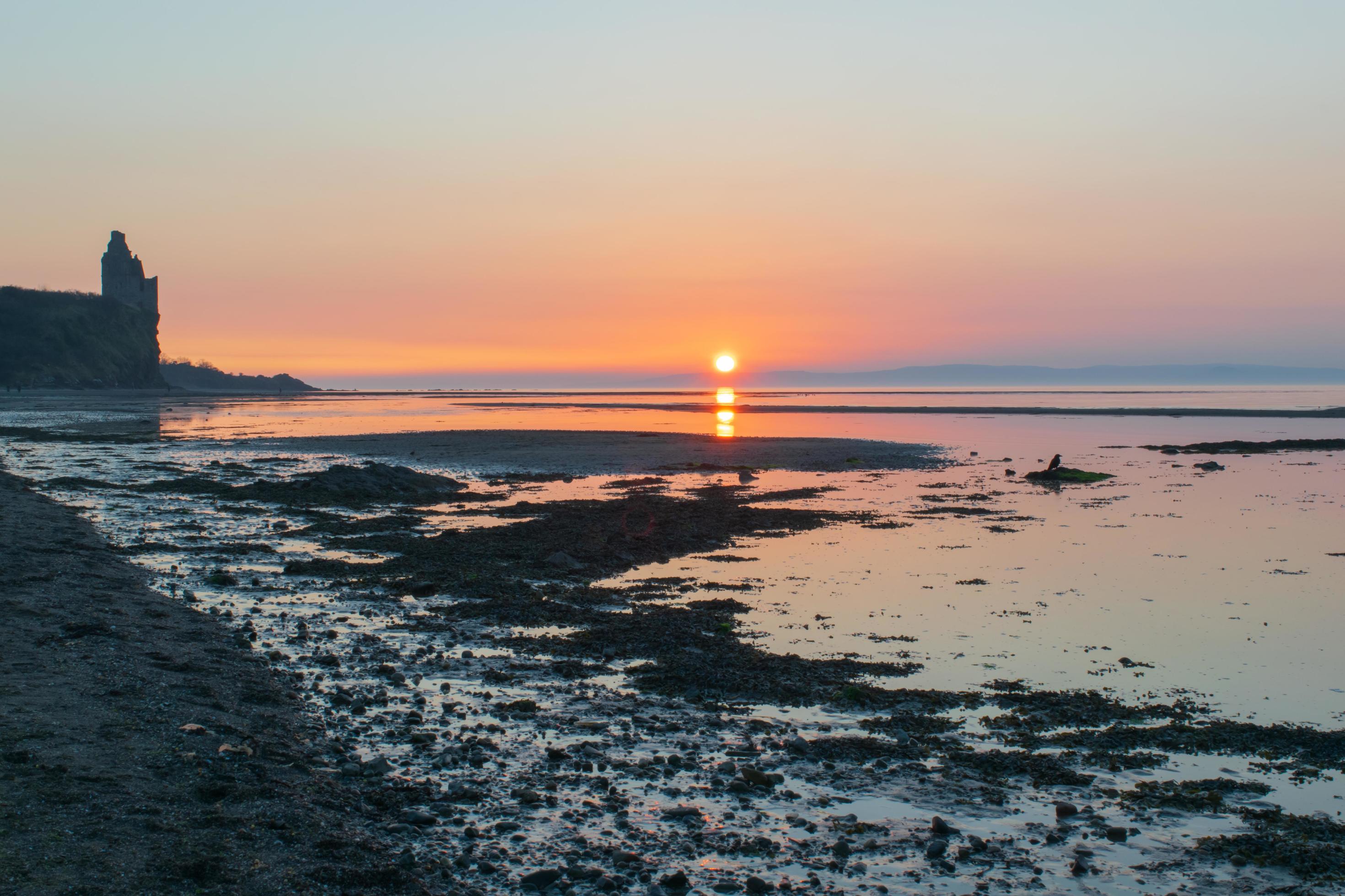 Sunset over the beach next to the Castle Stock Free