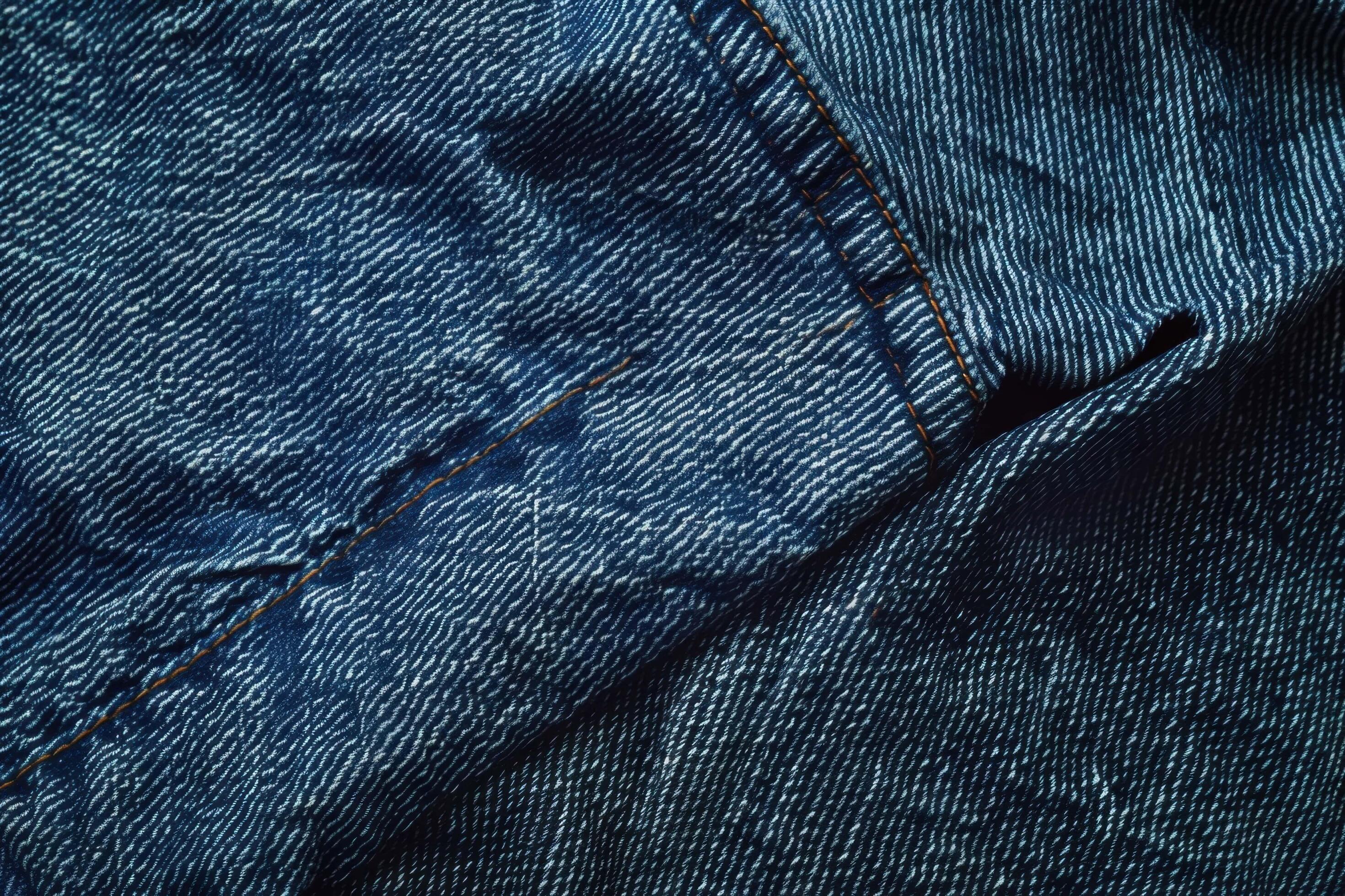 A denim texture background features a classic, rugged fabric with a distinctive twill weave pattern Stock Free