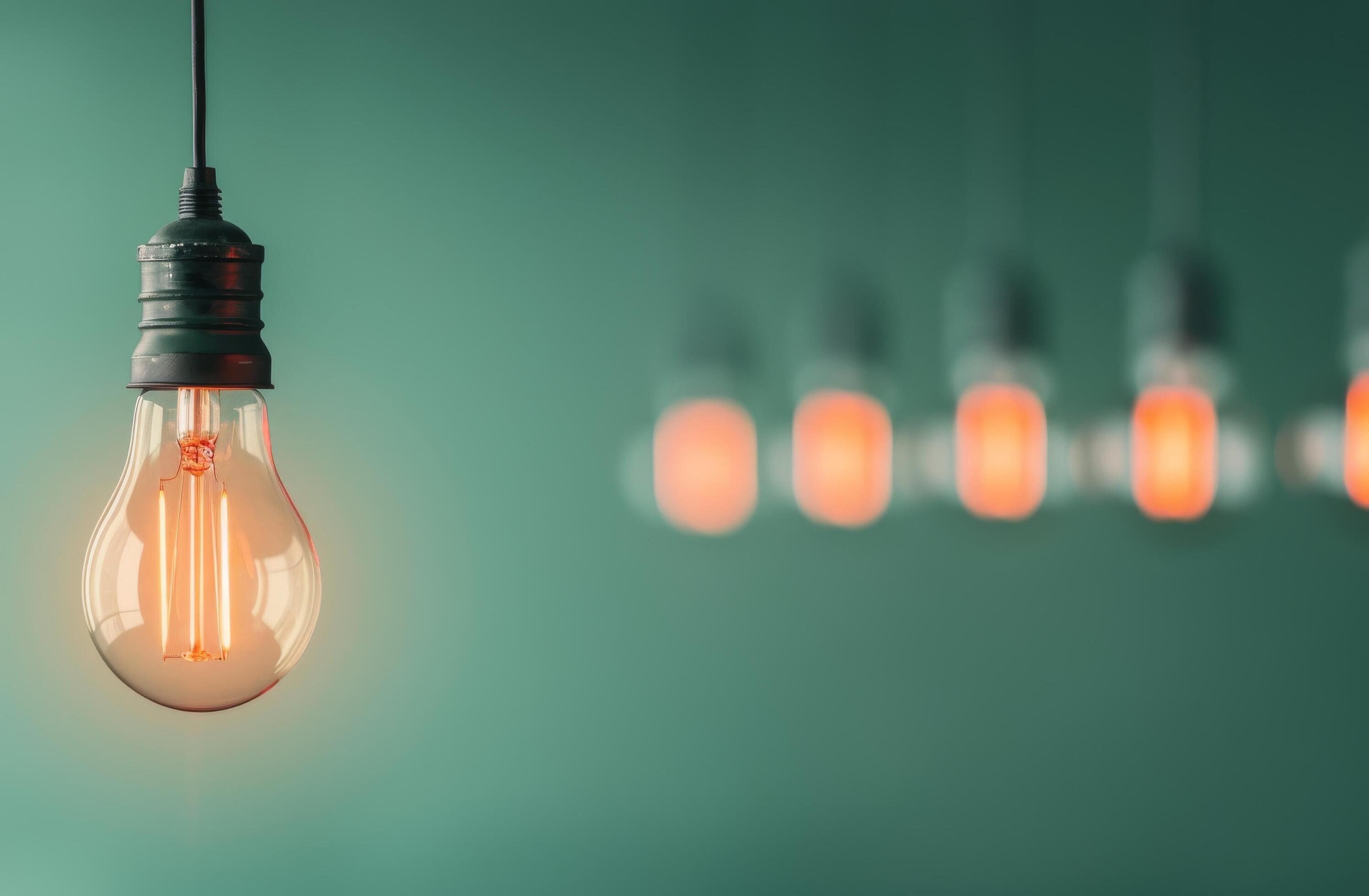 Light Bulb Hanging Against Green Background Stock Free