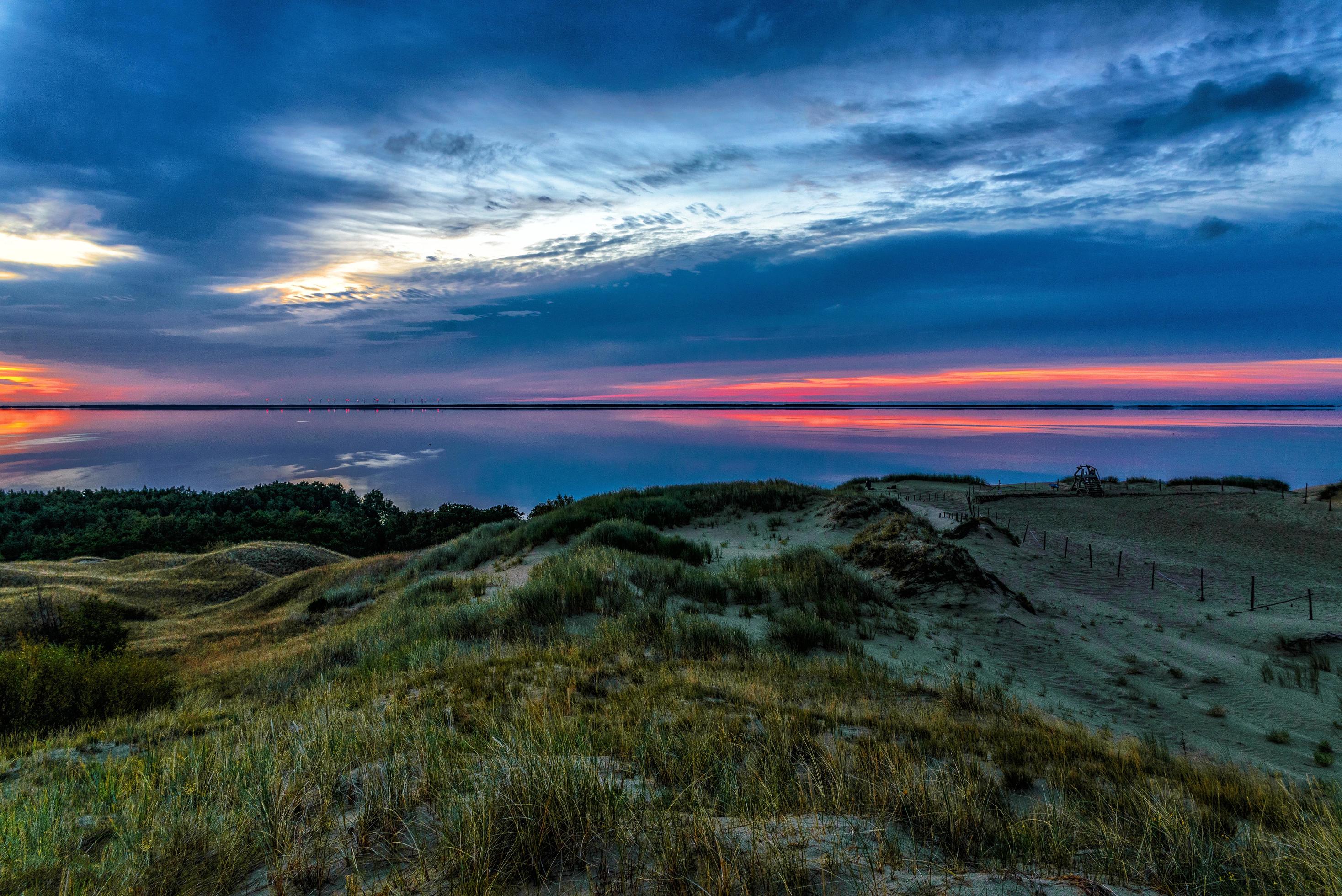 Body of water and dunes during sunset Stock Free