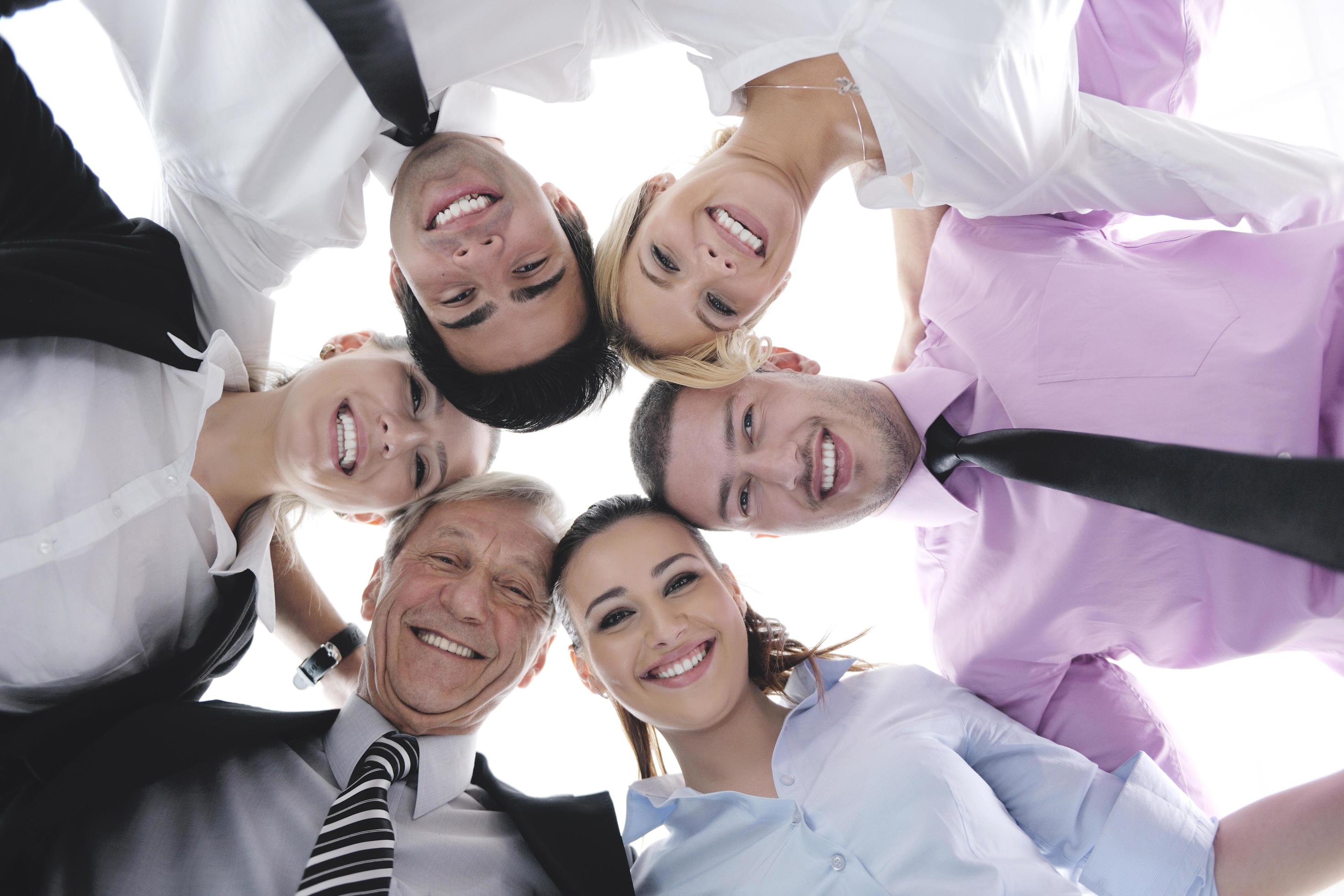 business people with their heads together Stock Free