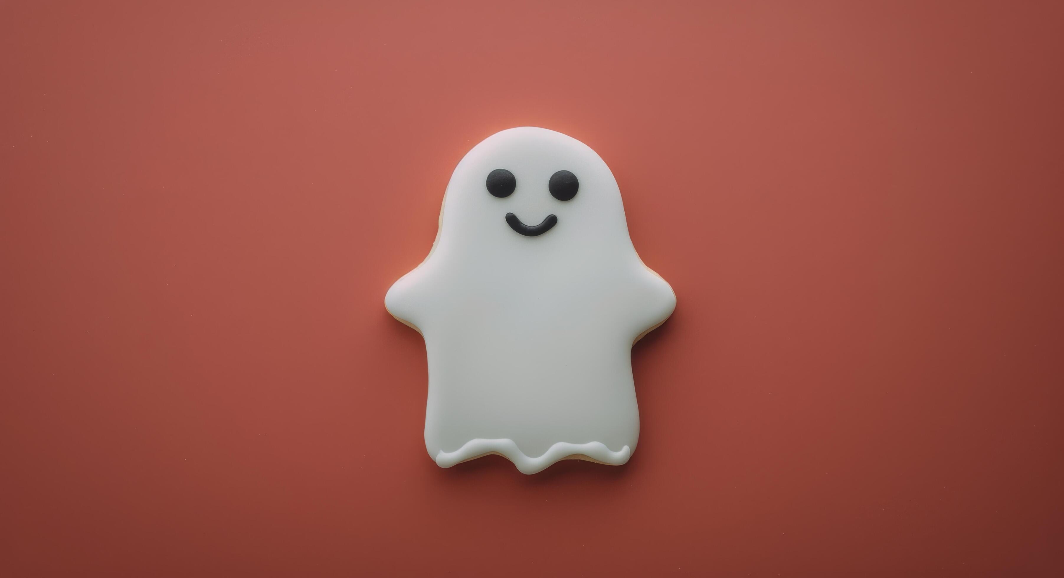 Cute Ghost-Shaped Cookie on Red Background for Halloween Celebration Stock Free