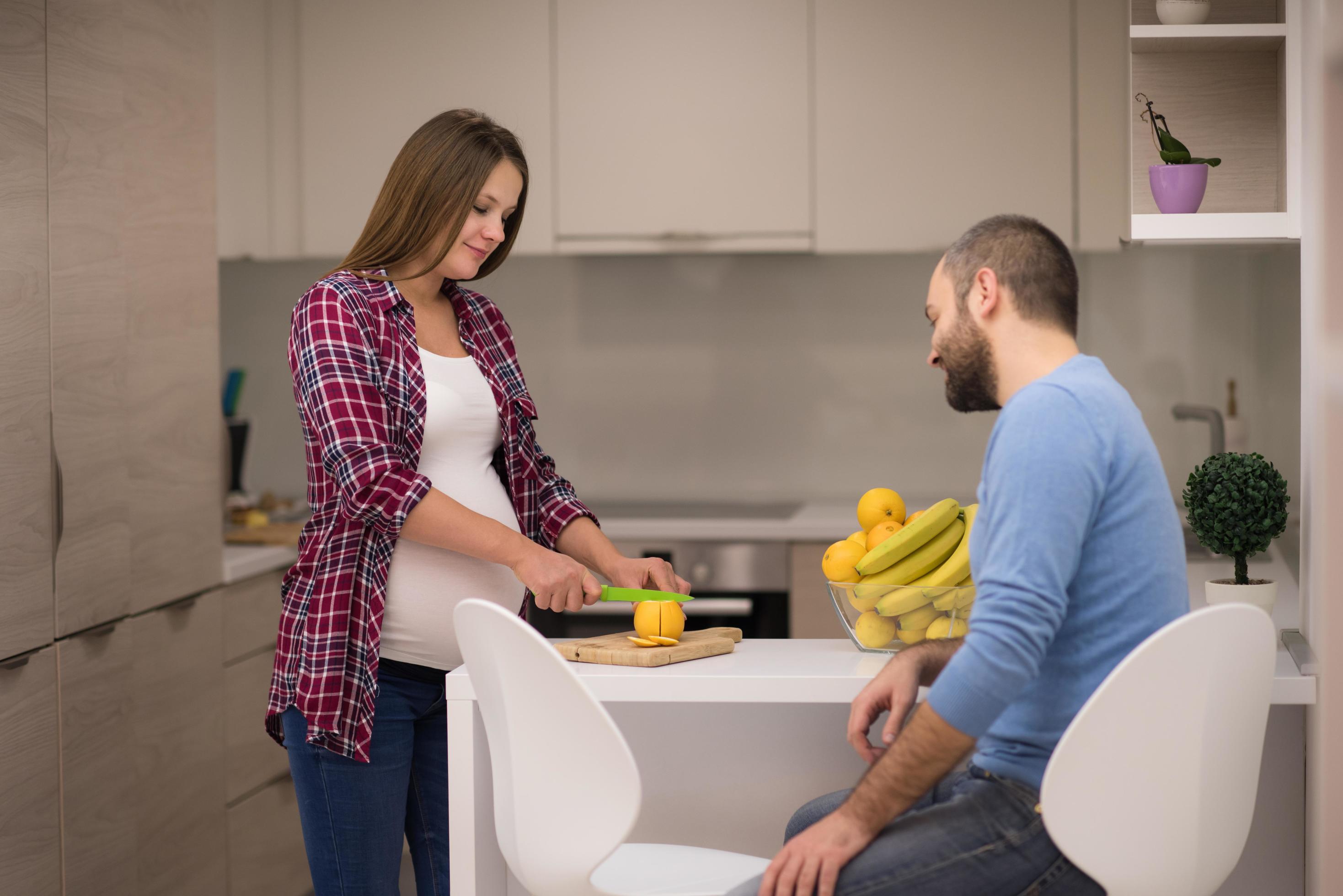 couple cooking food fruit lemon juice at kitchen Stock Free