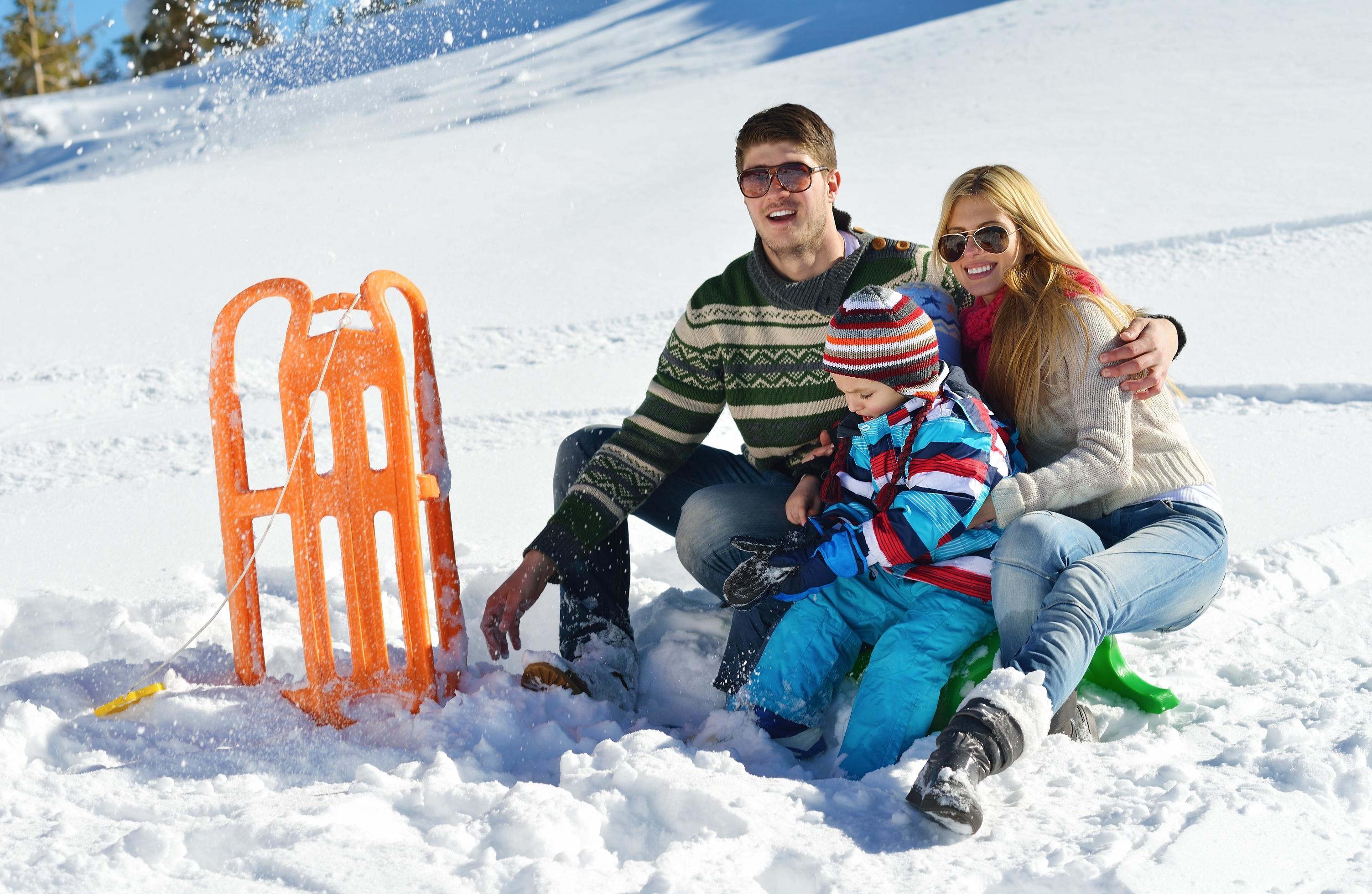 family having fun on fresh snow at winter Stock Free