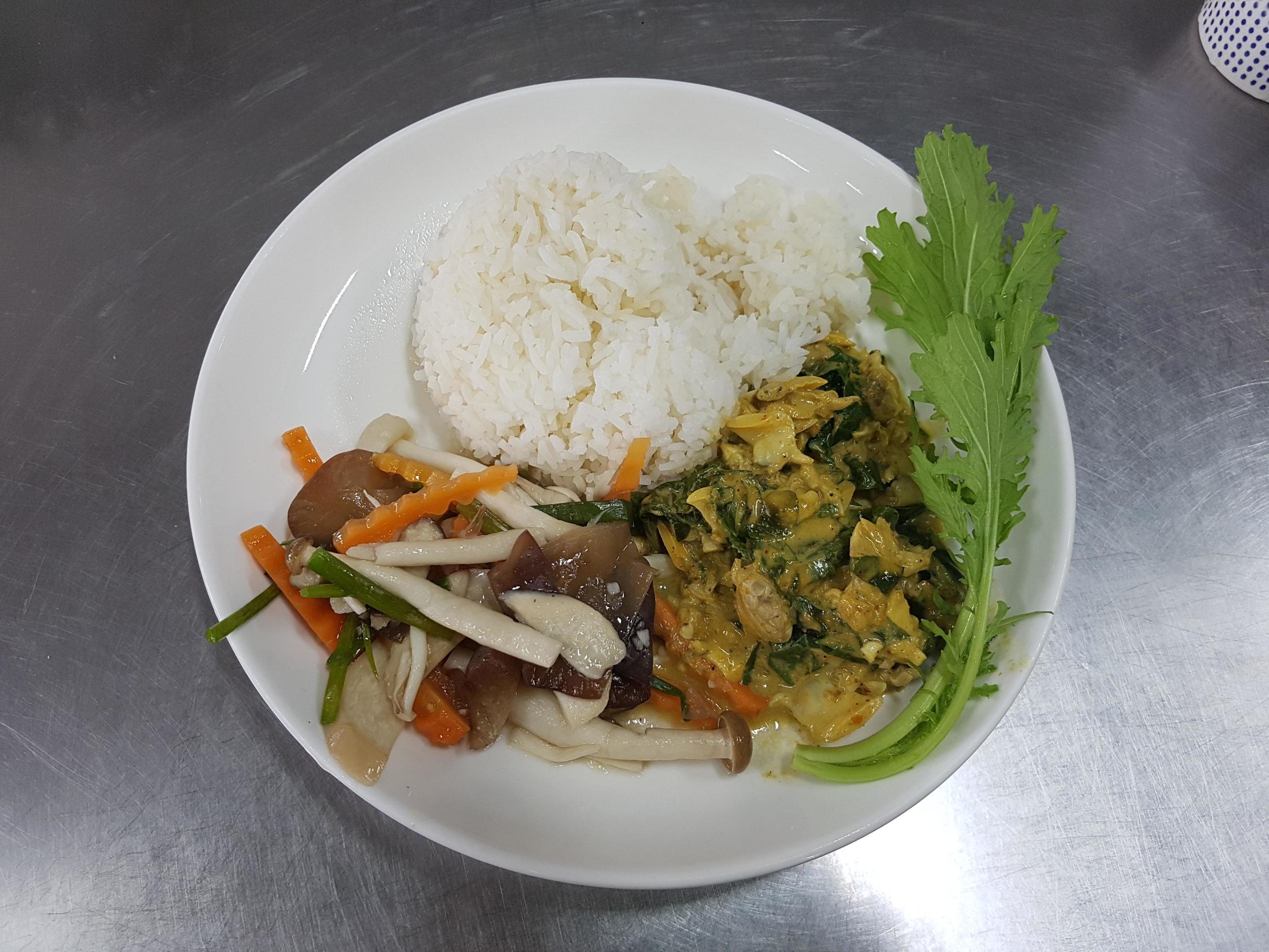 thai food on a white plate, green vegetables, mushrooms, clams, glare of light. Stock Free