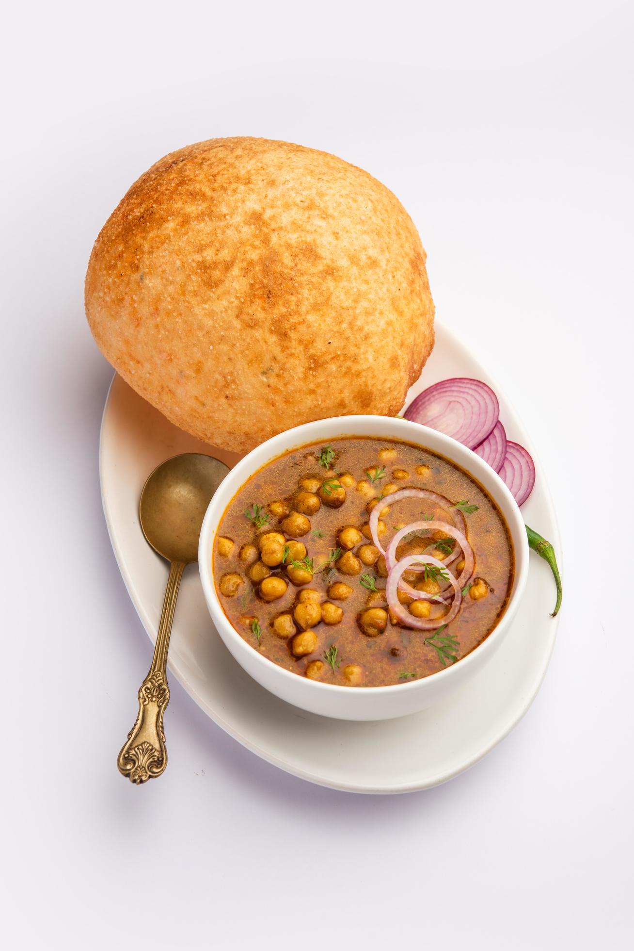 Chole bhature is a North Indian food dish. A combination of chana masala and bhatura or puri Stock Free