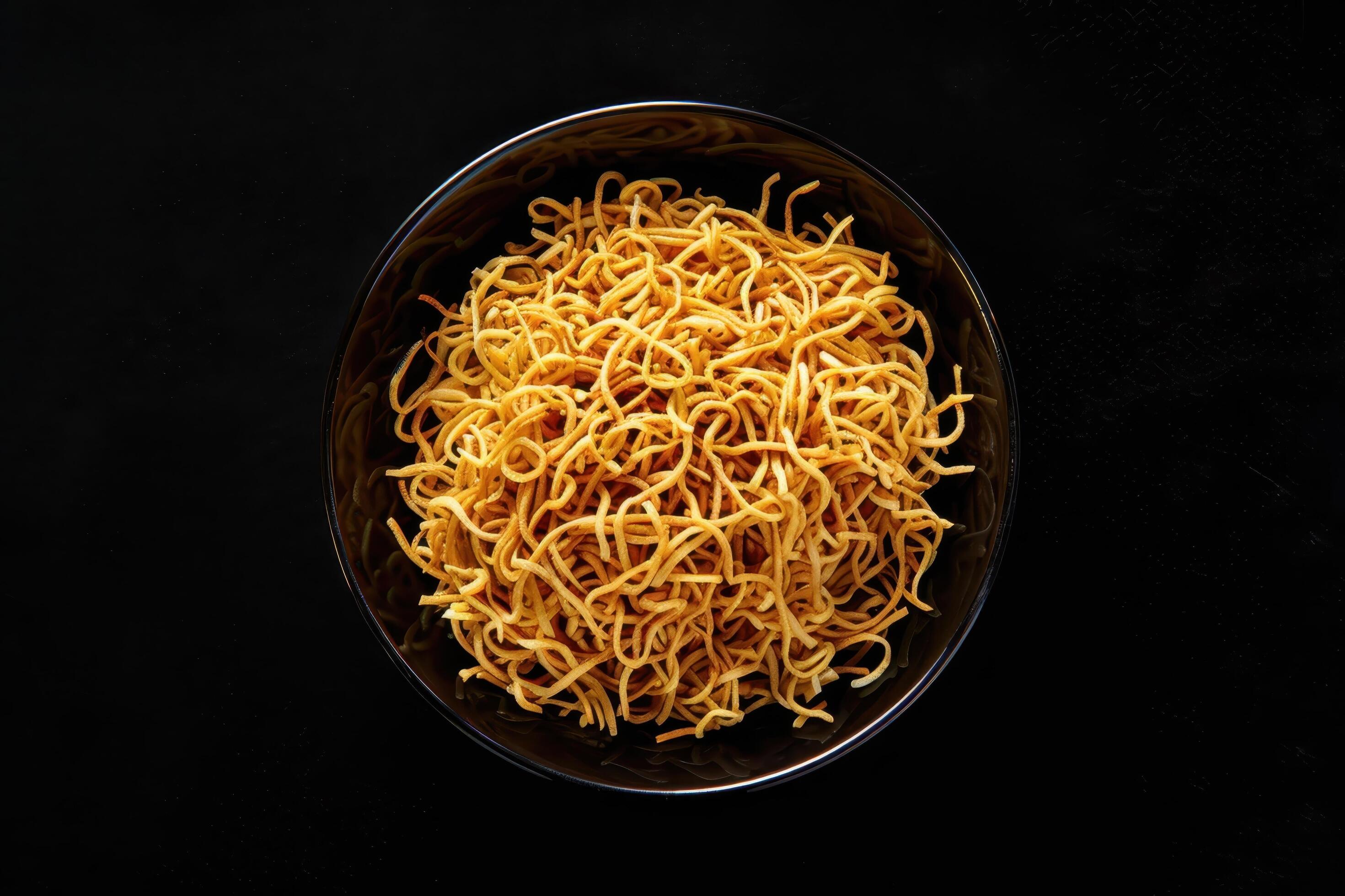 Crispy Noodles in a Black Bowl on a Dark Background Stock Free