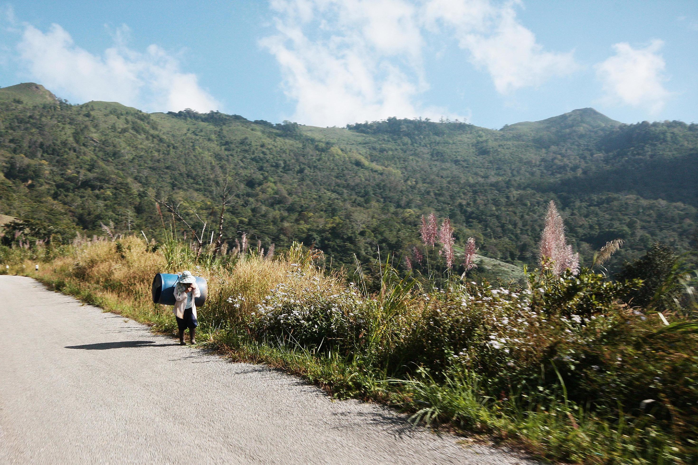 Life of hill tribe farmers walking in country road on the mountain in Thailand Stock Free