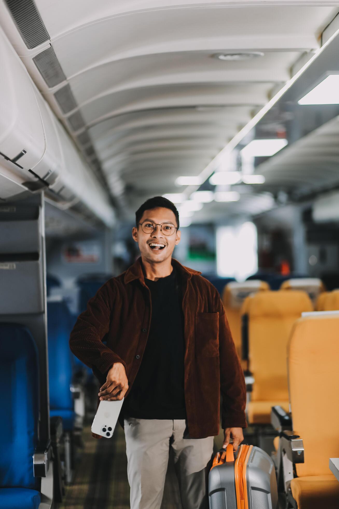 Low Section of Passenger Businessman Walking with Suitcase at the Entrance Walkway in Airport. Focus on Luggage. Low Angle View Stock Free