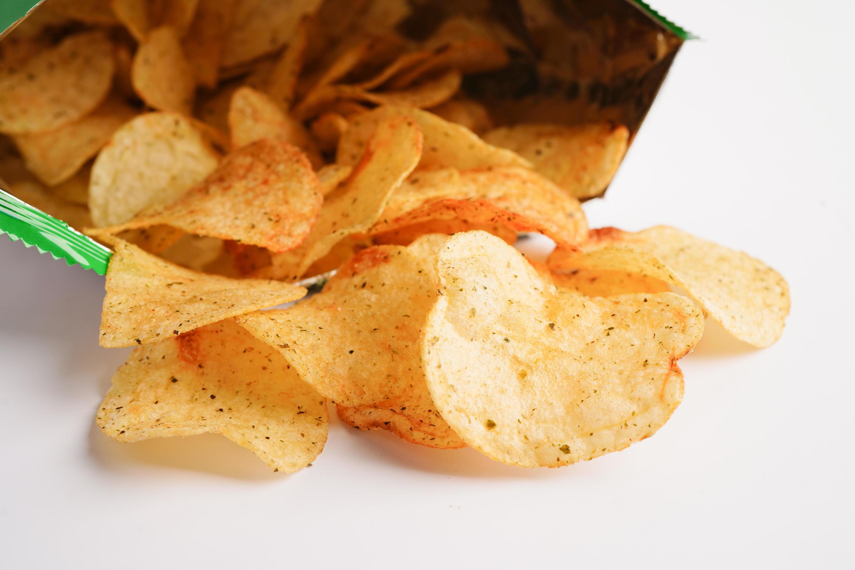 Potato chips in open bag, delicious BBQ seasoning spicy for crips, thin slice deep fried snack fast food in open bag. Stock Free