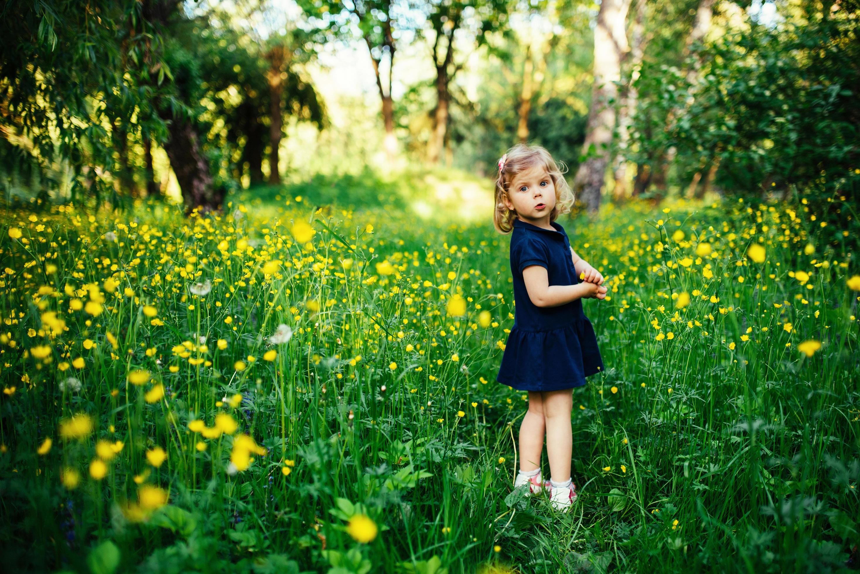 child playing outdoors in the grass Stock Free