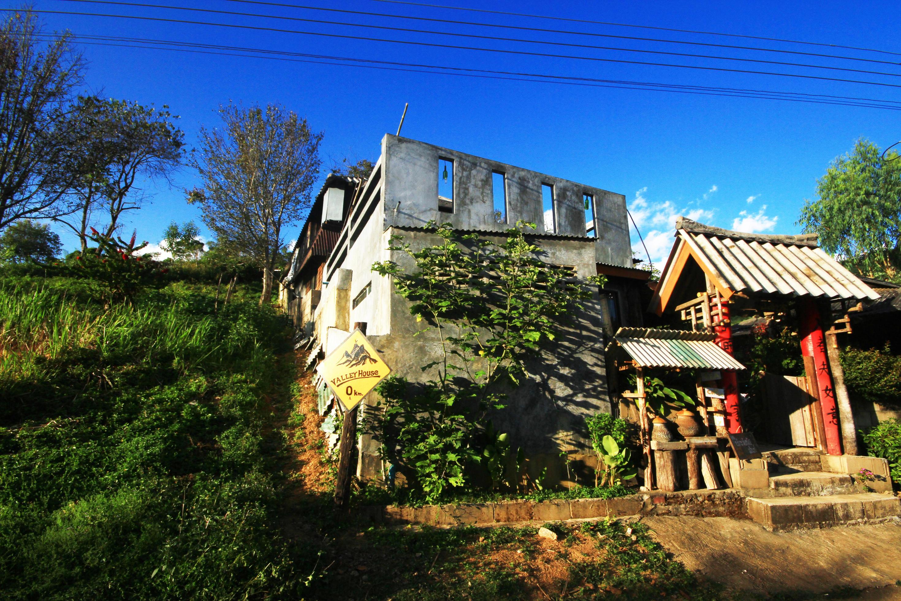 Yunnan Chinese hilltribe houses on the mountain with beautiful blue sky and sunlight in northern Thailand Stock Free