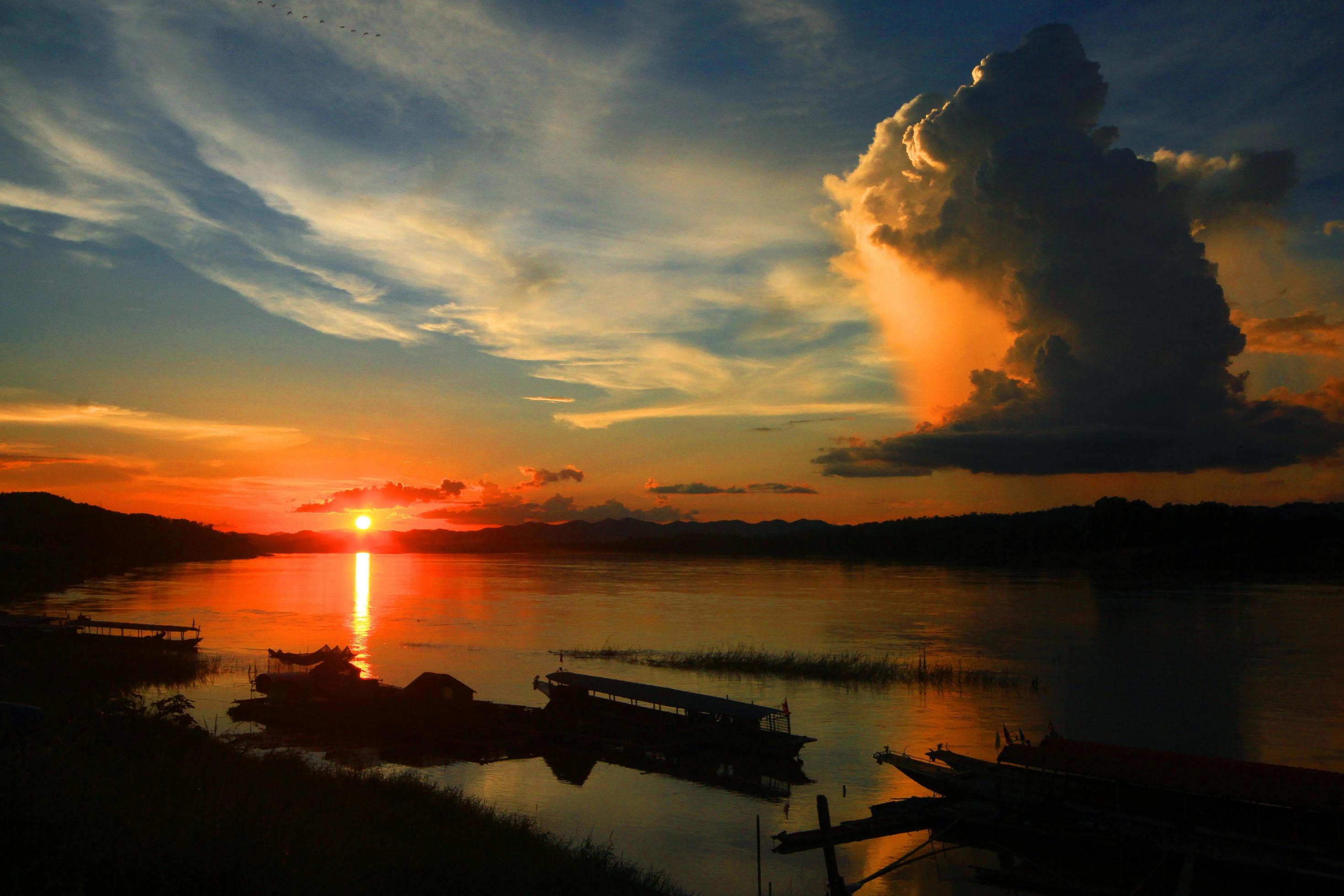 Tradition of Long tail boat and fisherman in beautiful sunset twilight at Khong river the Thai-Laos border Chaingkhan distric Thailand Stock Free