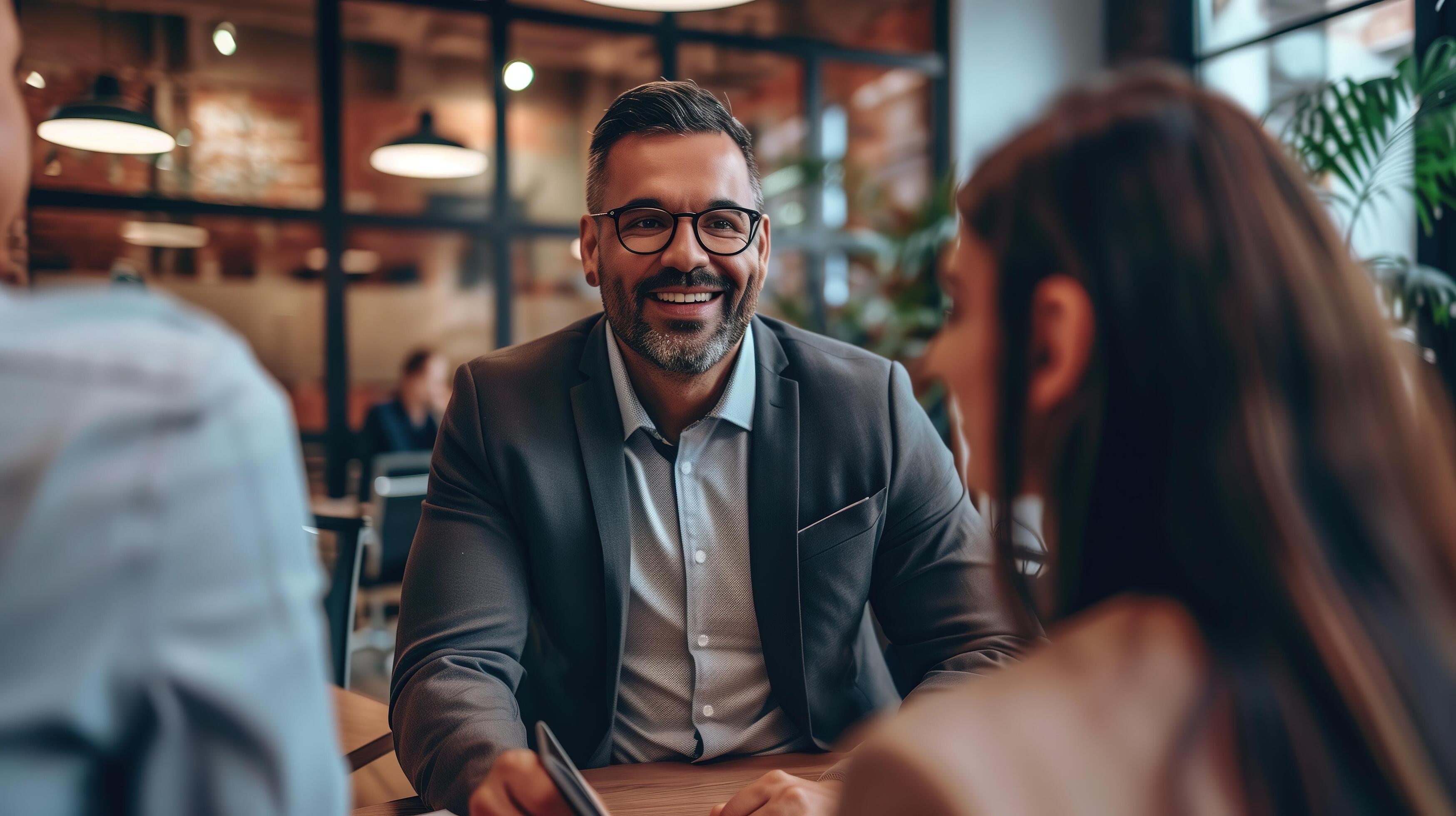 A confident financial advisor explaining investment options to attentive clients in a sleek, professional office environment Stock Free