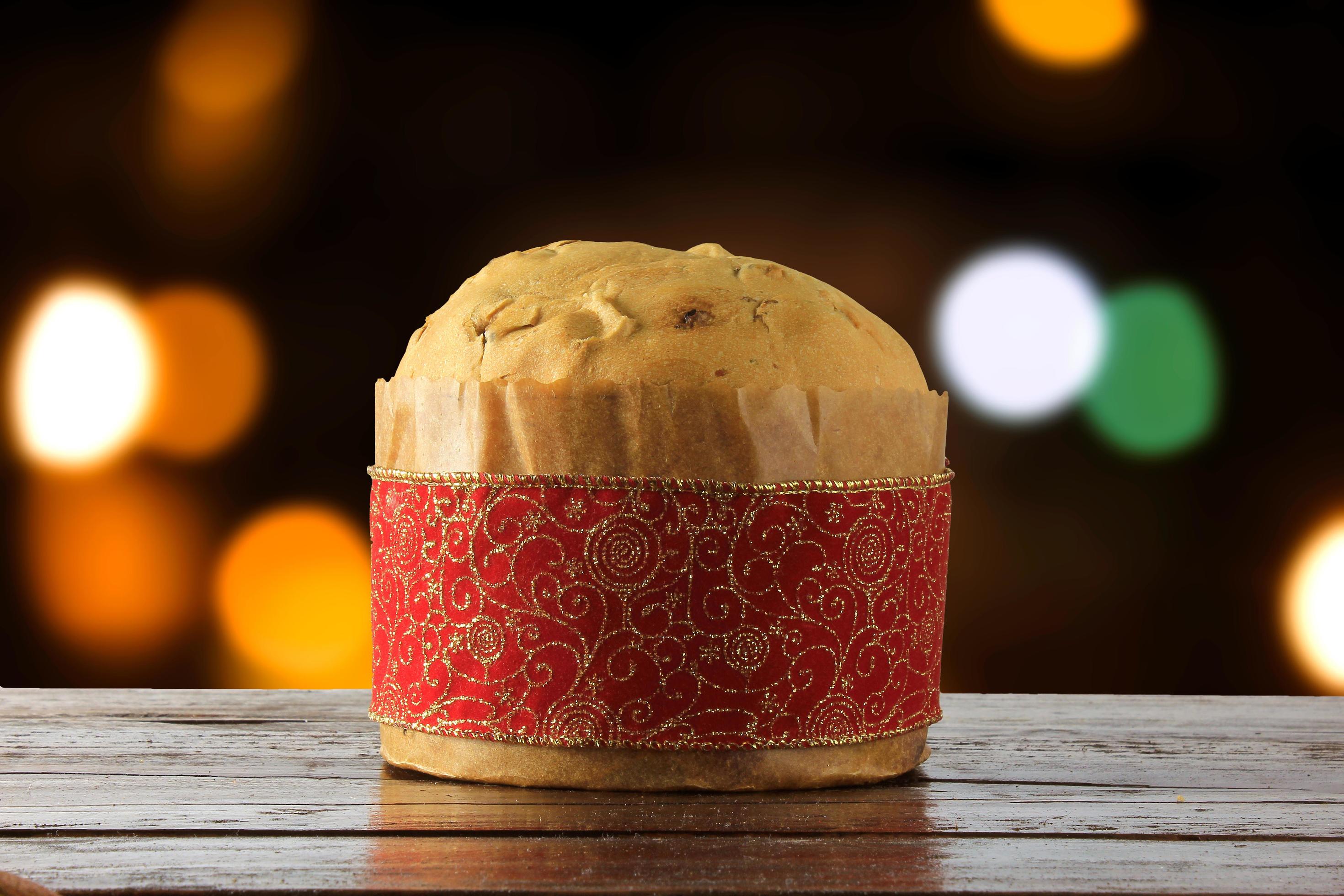 panettone, decorative food, on wooden table, blurred lights in the background Stock Free