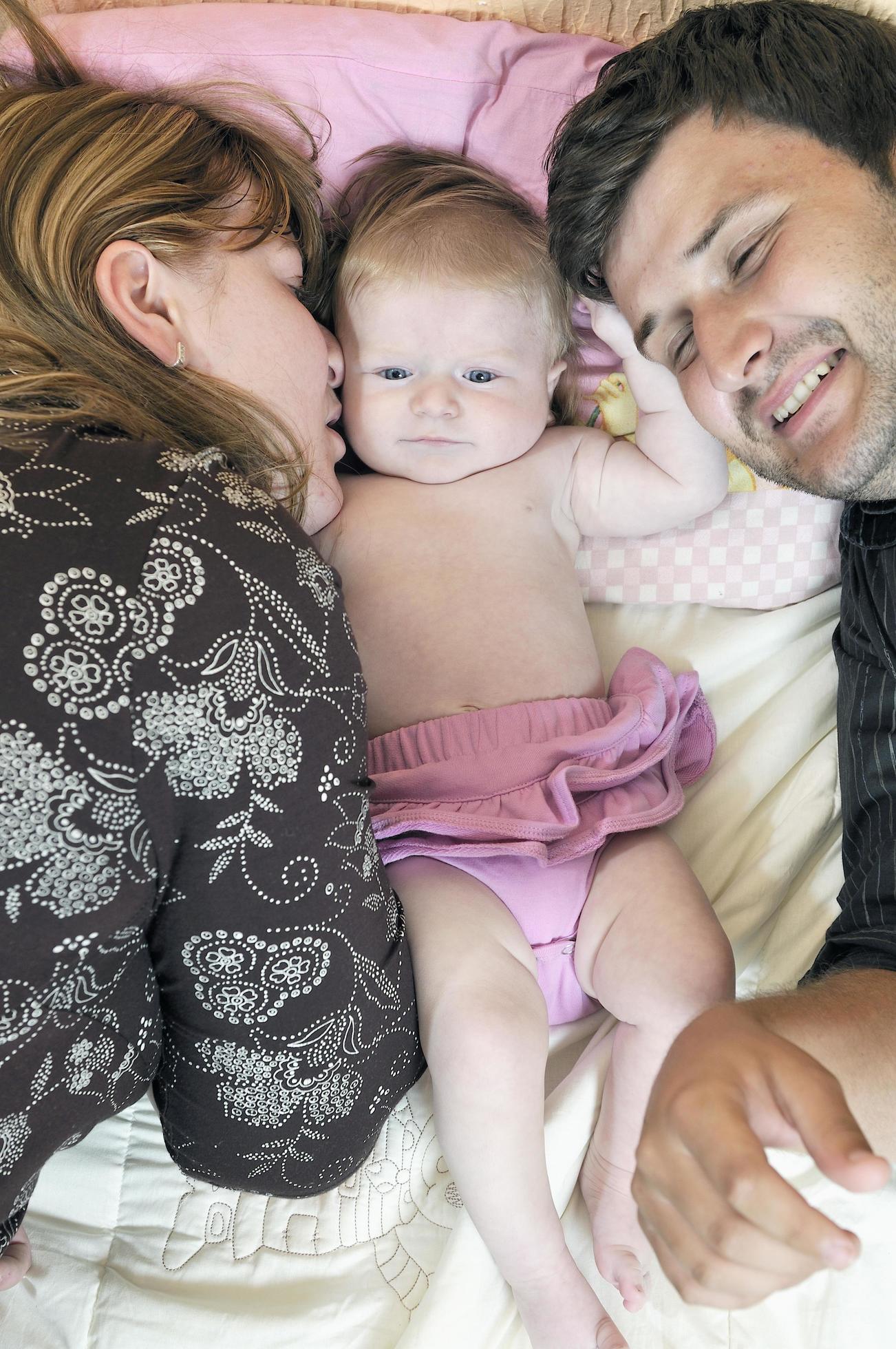 portrait of young family with cute little babby Stock Free