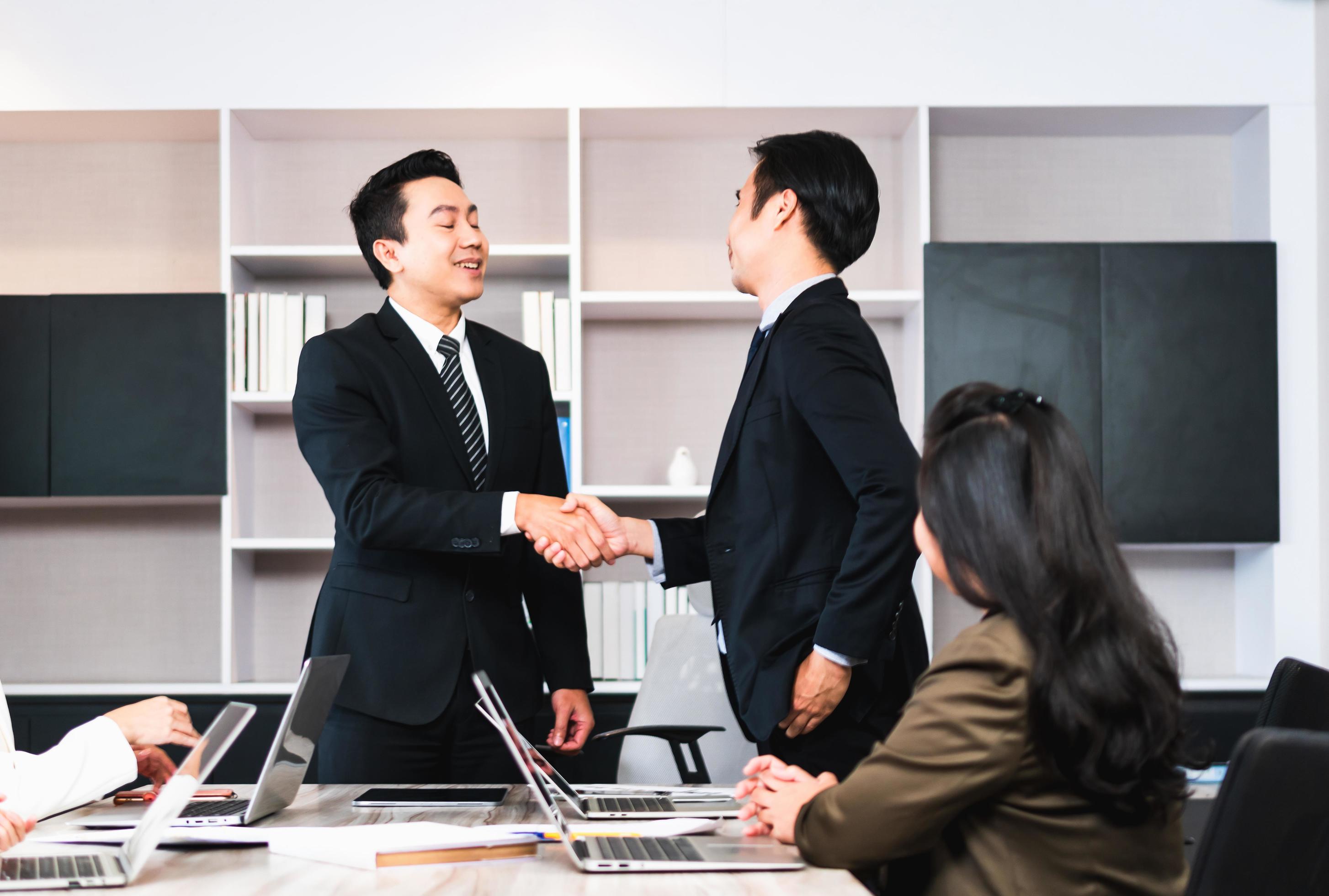 Success and happiness teamwork concept, Businessman handshake finishing up a meeting business partnership after good deal Stock Free