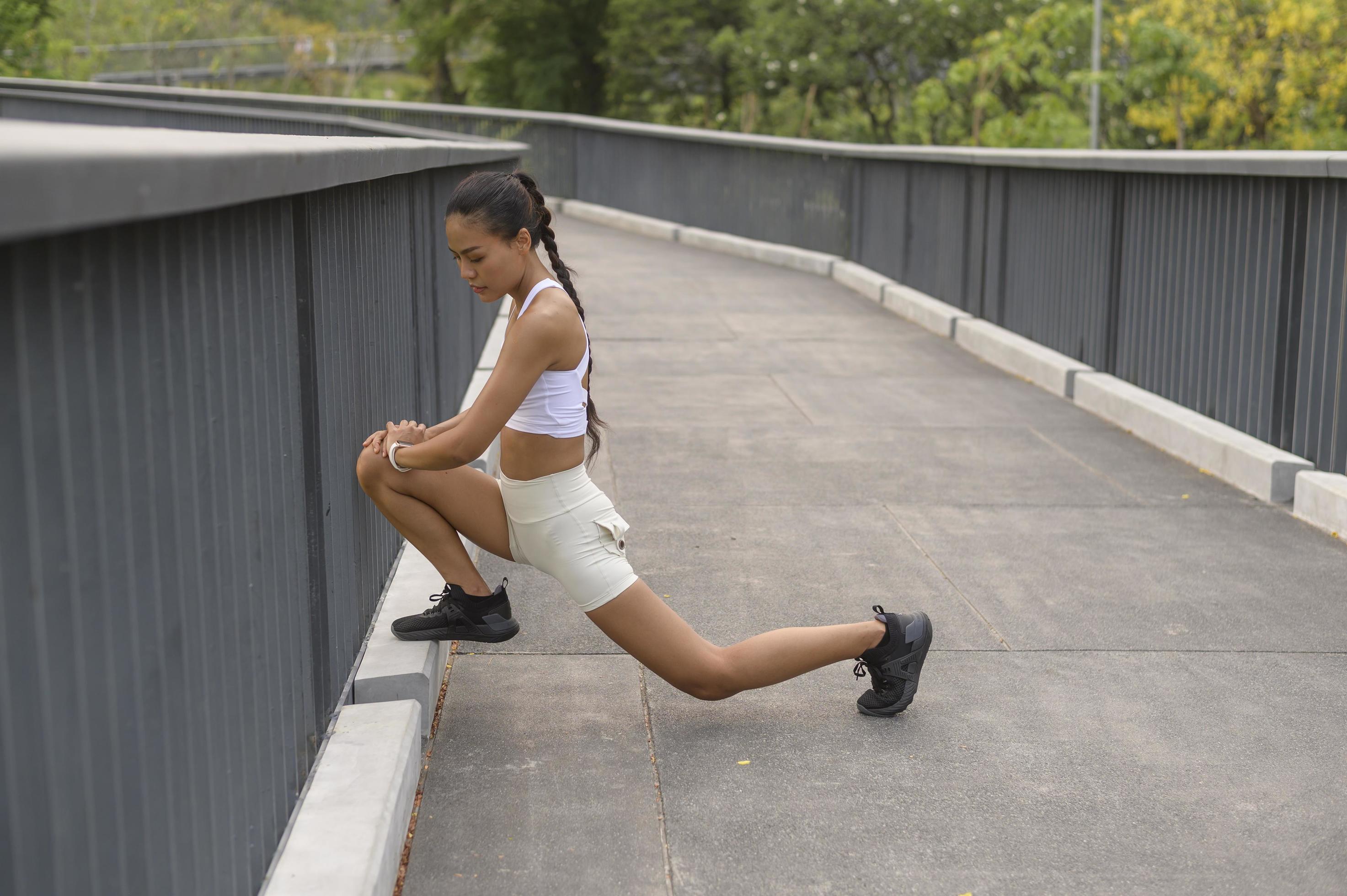 A young fitness woman in sportswear exercising in city park, Healthy and Lifestyles. Stock Free