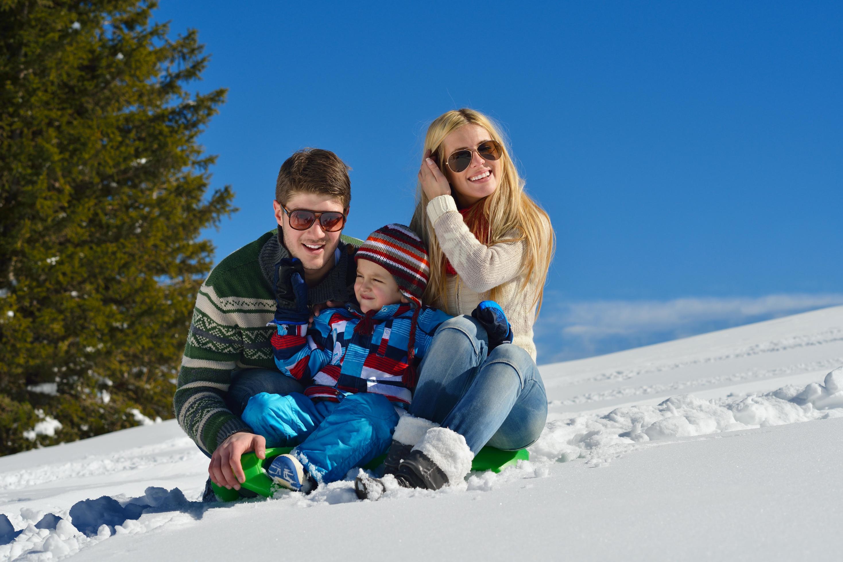 family having fun on fresh snow at winter Stock Free