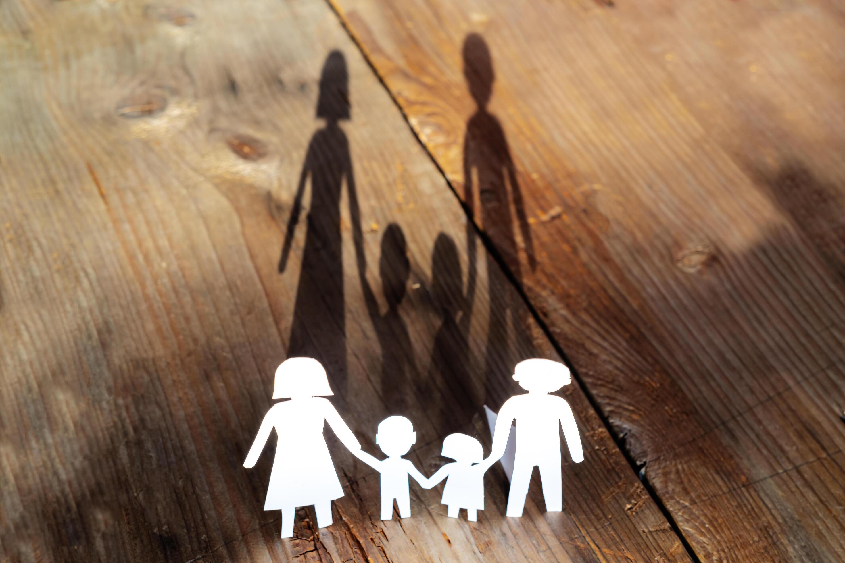 The family of paper cut placed on a wooden table Stock Free