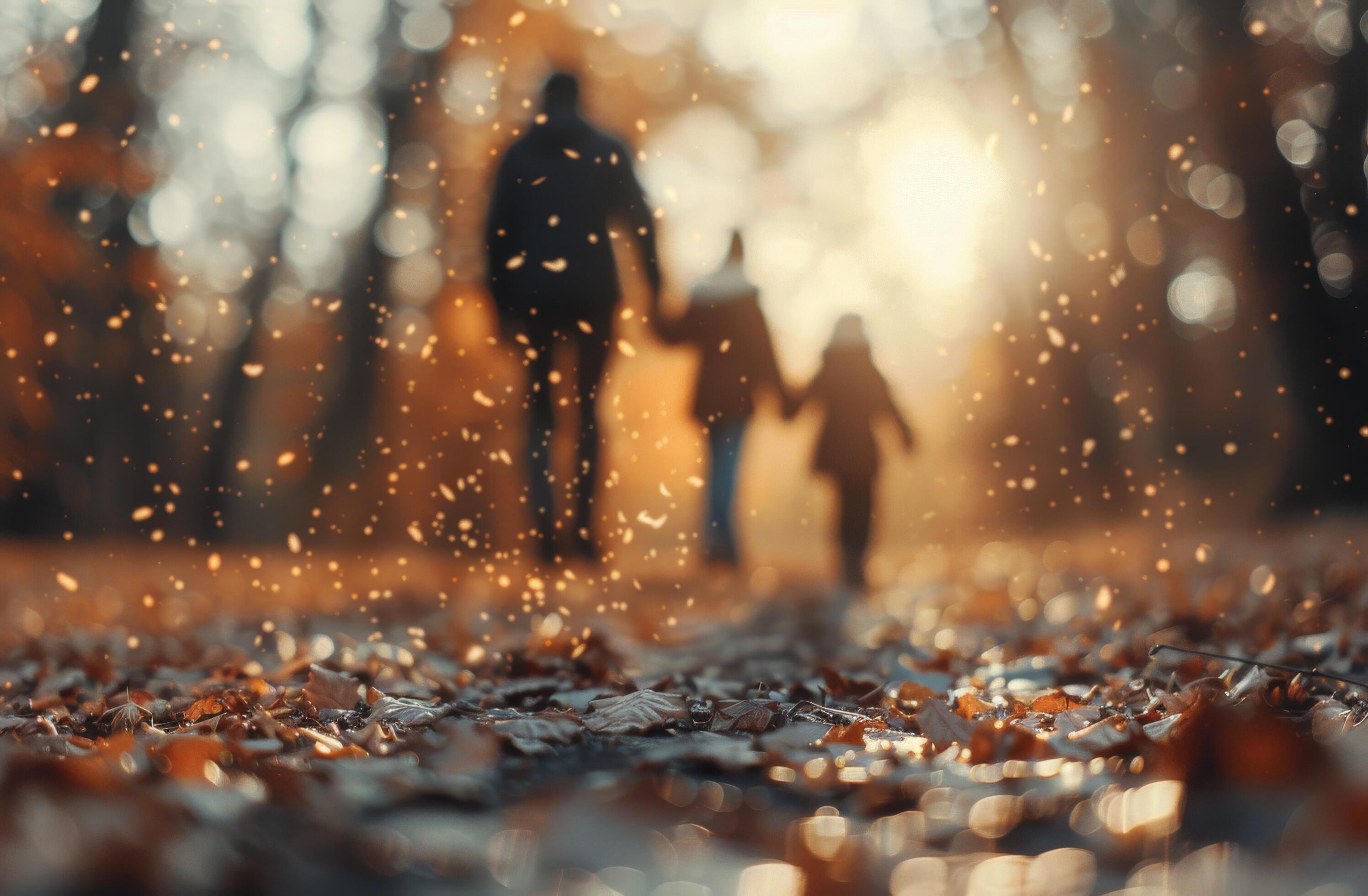 Family Walking Through Autumn Leaves in a Sunlit Park During Golden Hour Stock Free