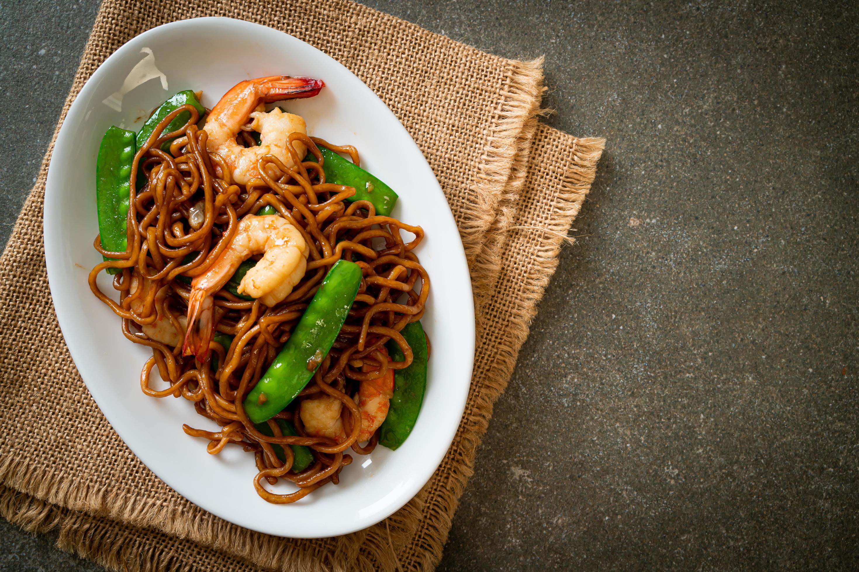 Stir-fried yakisoba noodles with green peas and shrimps – Asian food style Stock Free