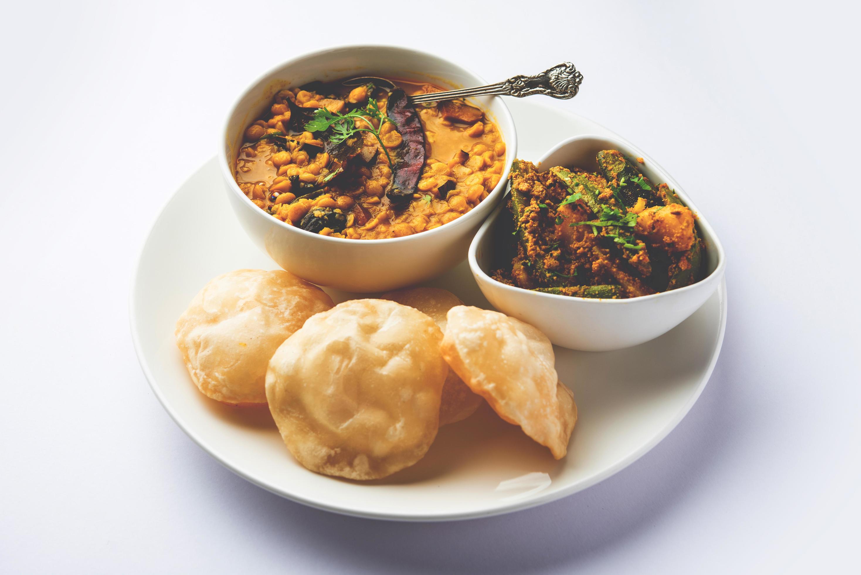 Cholar dal and patol aloo sabzi served with fried Luchi or poori, bengali food Stock Free