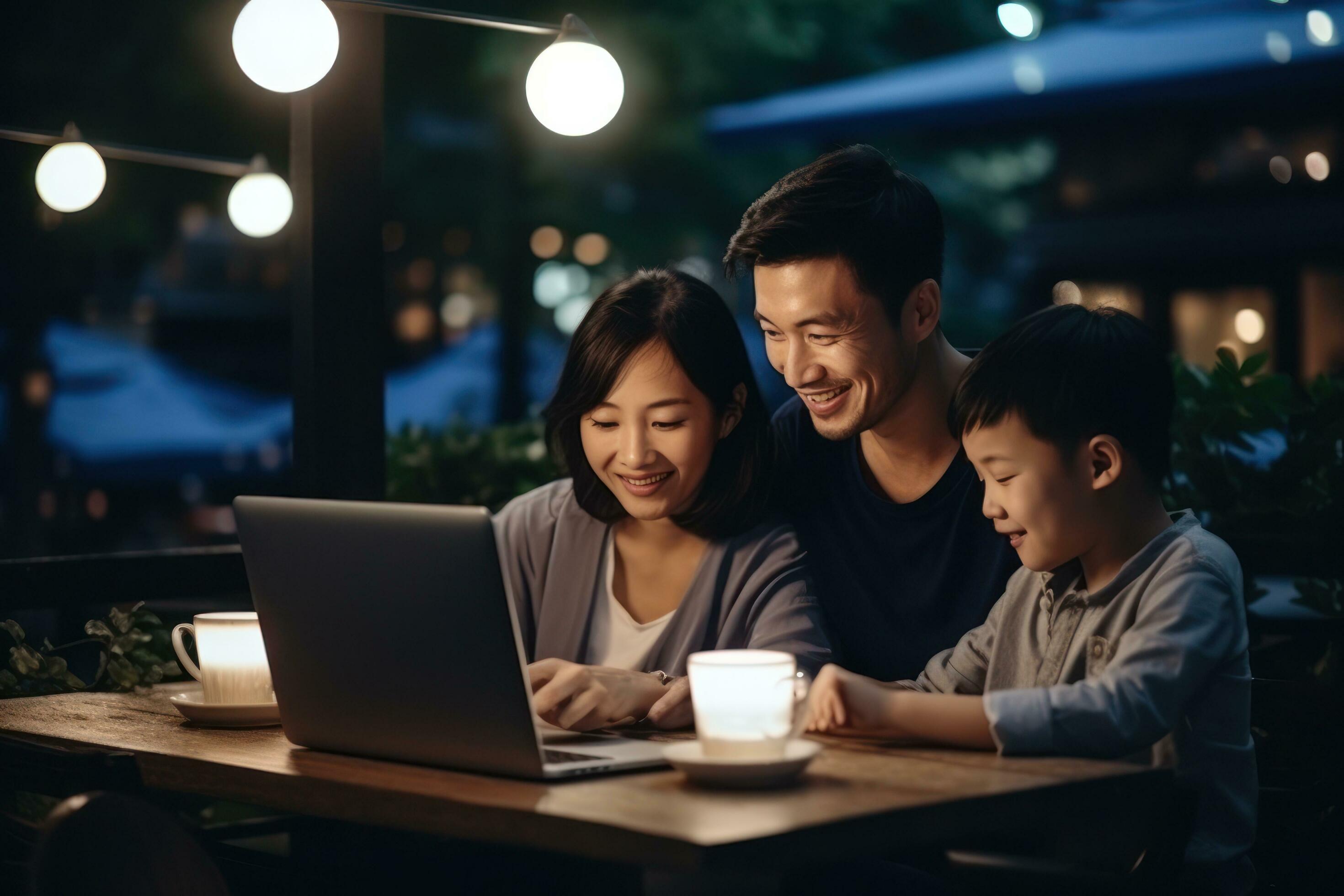 Family is looking at a laptop while sitting on a sofa Stock Free