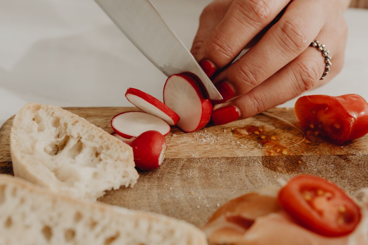 Woman making bruschetta with healthy ingredients Stock Free