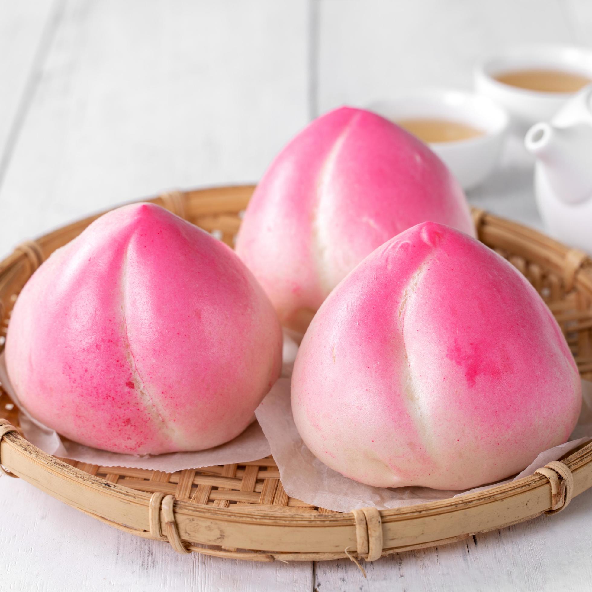 Pink Chinese peach birthday bun food on white table background. Stock Free